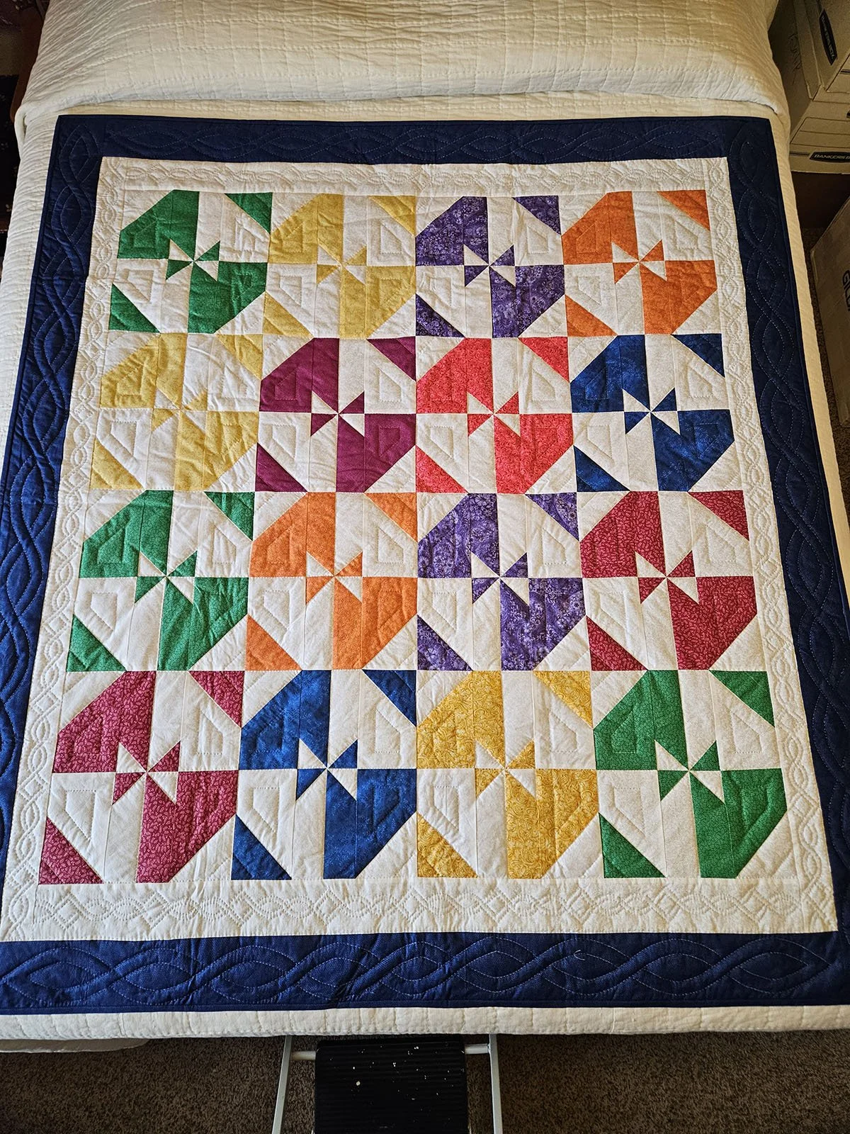 Shadows, Quilt Lap/Throw, 56x63: Material Resources Center of Ephrata, Pa.

Bright green, yellow, purple, orange, blue and red triangles are offset by white triangles to create shadows in this throw size quilt.  It's surrounded by a white inner borde