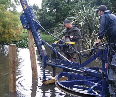 Revolution 180 post driver being used to drive posts in flooded conditions