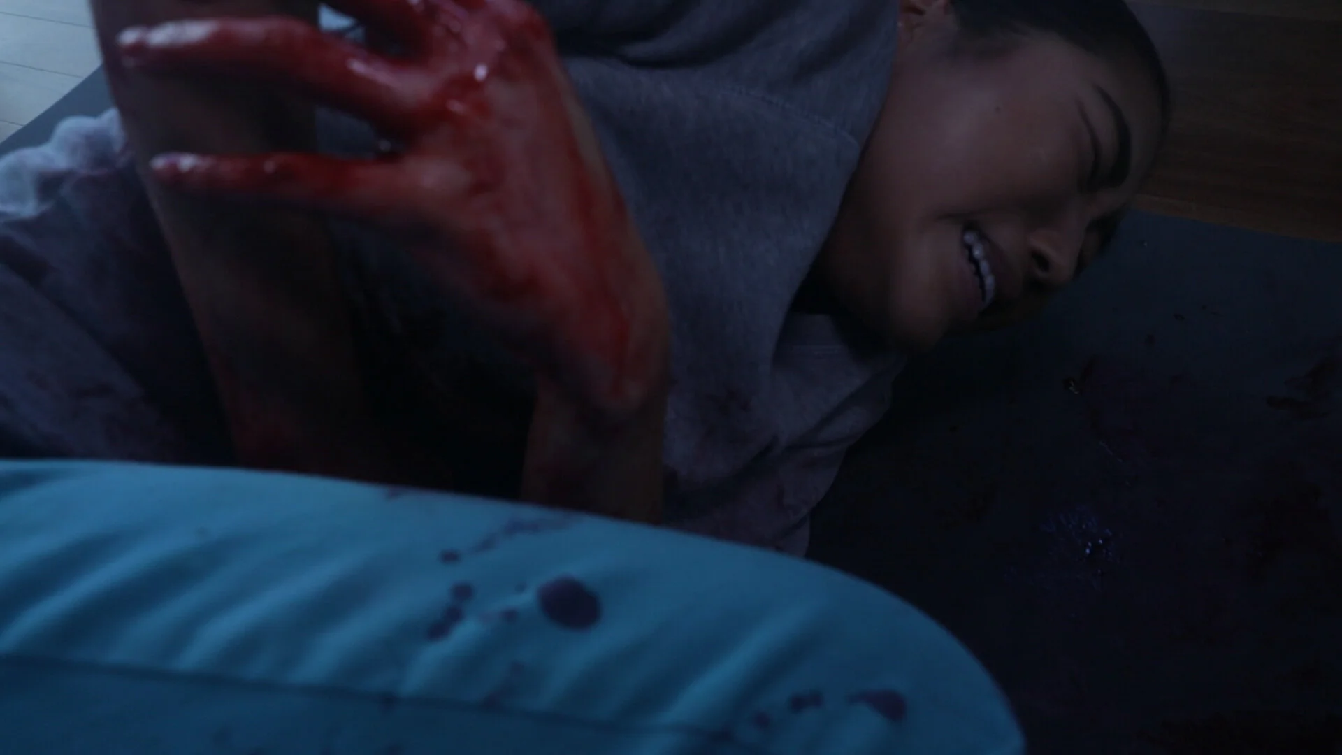 A still from The Wounded and The Watcher showing The Wounded on the ground.