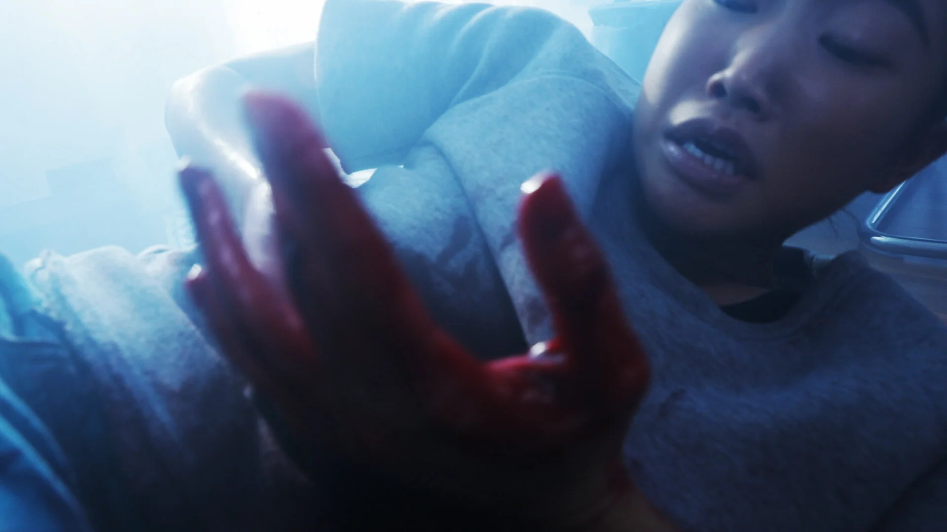 A still from The Wounded and The Watcher showing the wounded hurt on the ground.