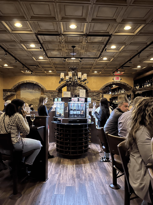 Self-pour wine dispensers in wine bar and restaurant