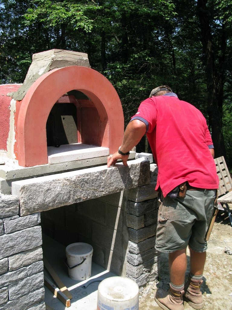 John adds a detail to the oven front.