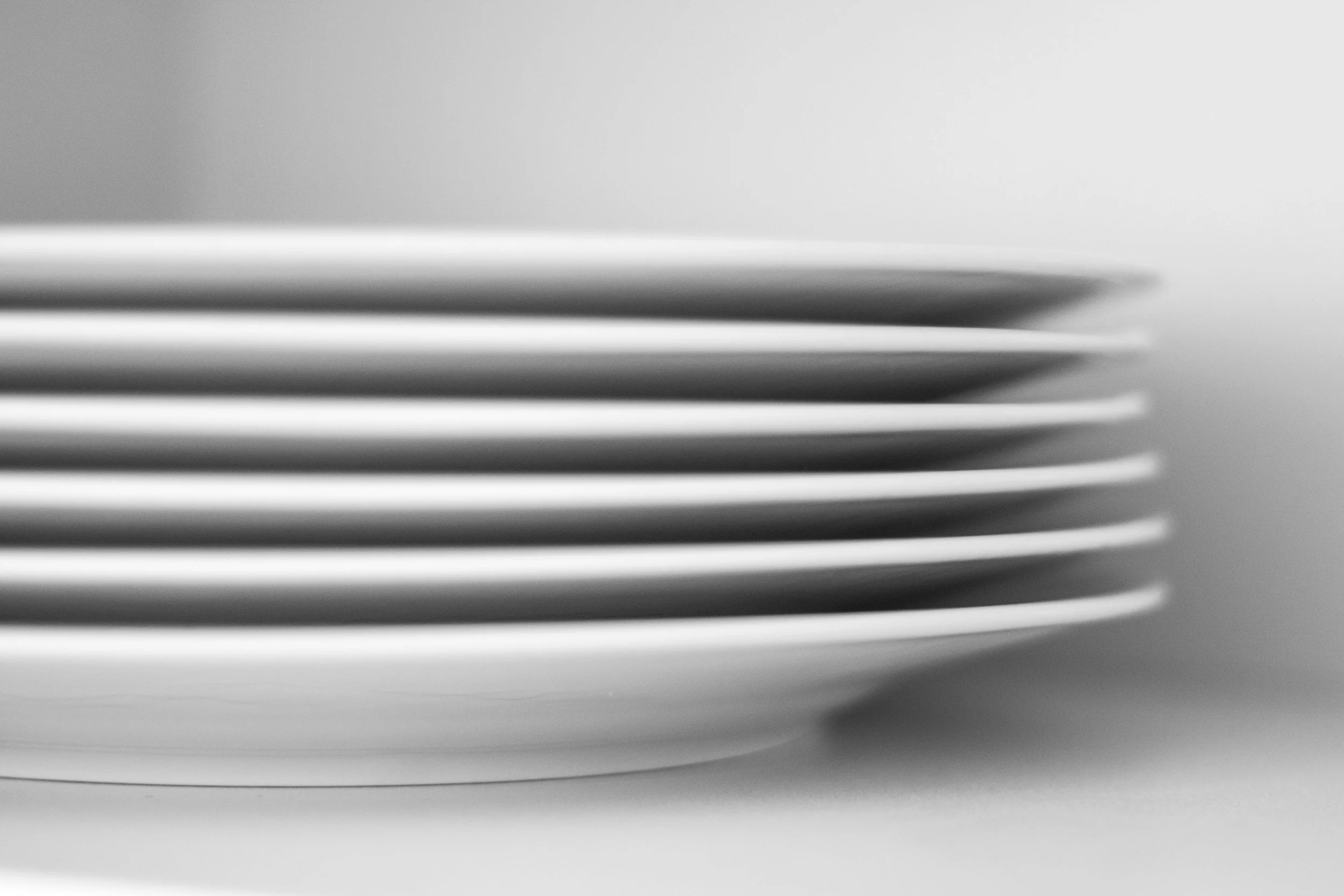 image of perfectly stacked white dinner plates