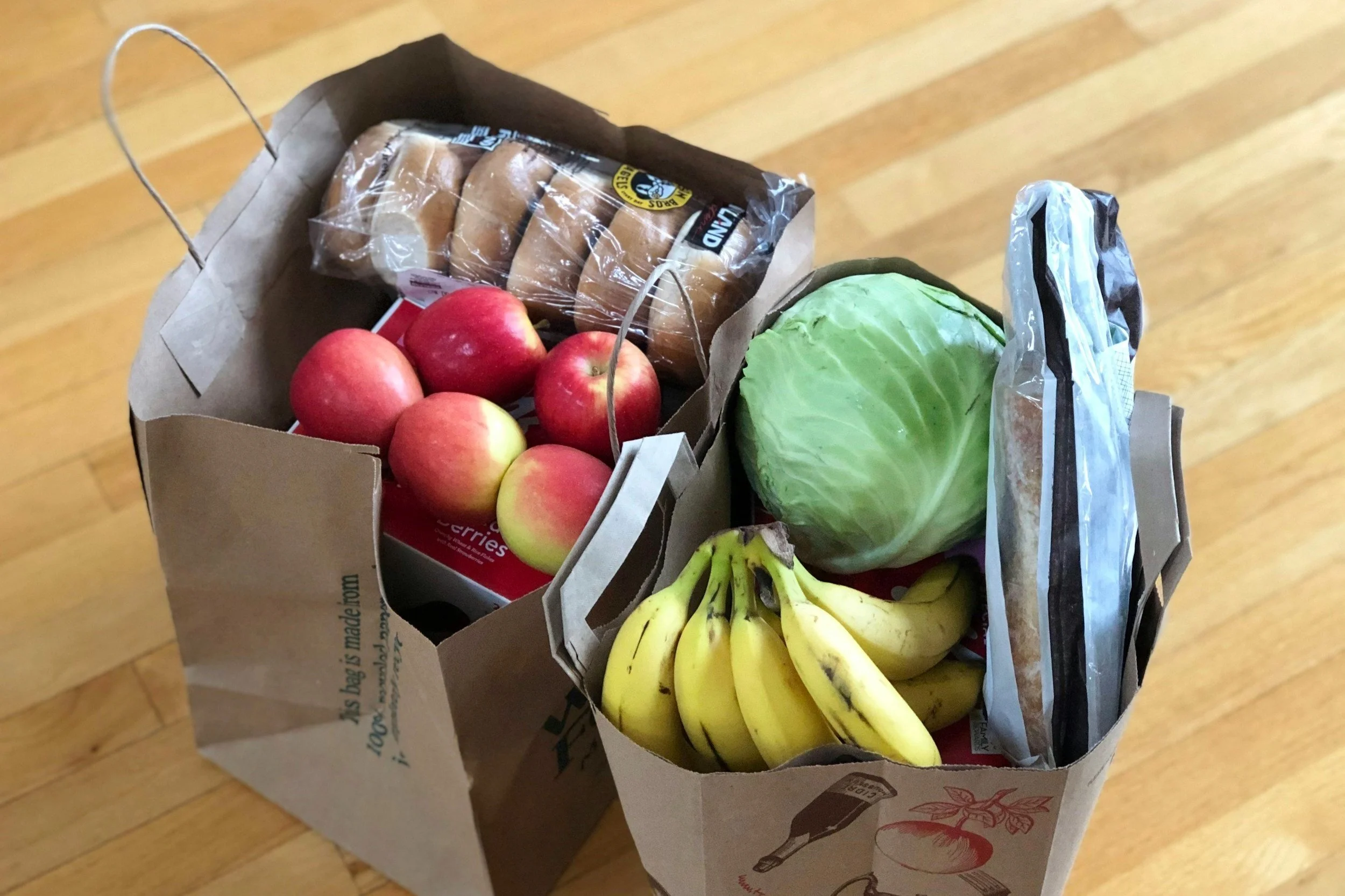 two paper bags full of groceries