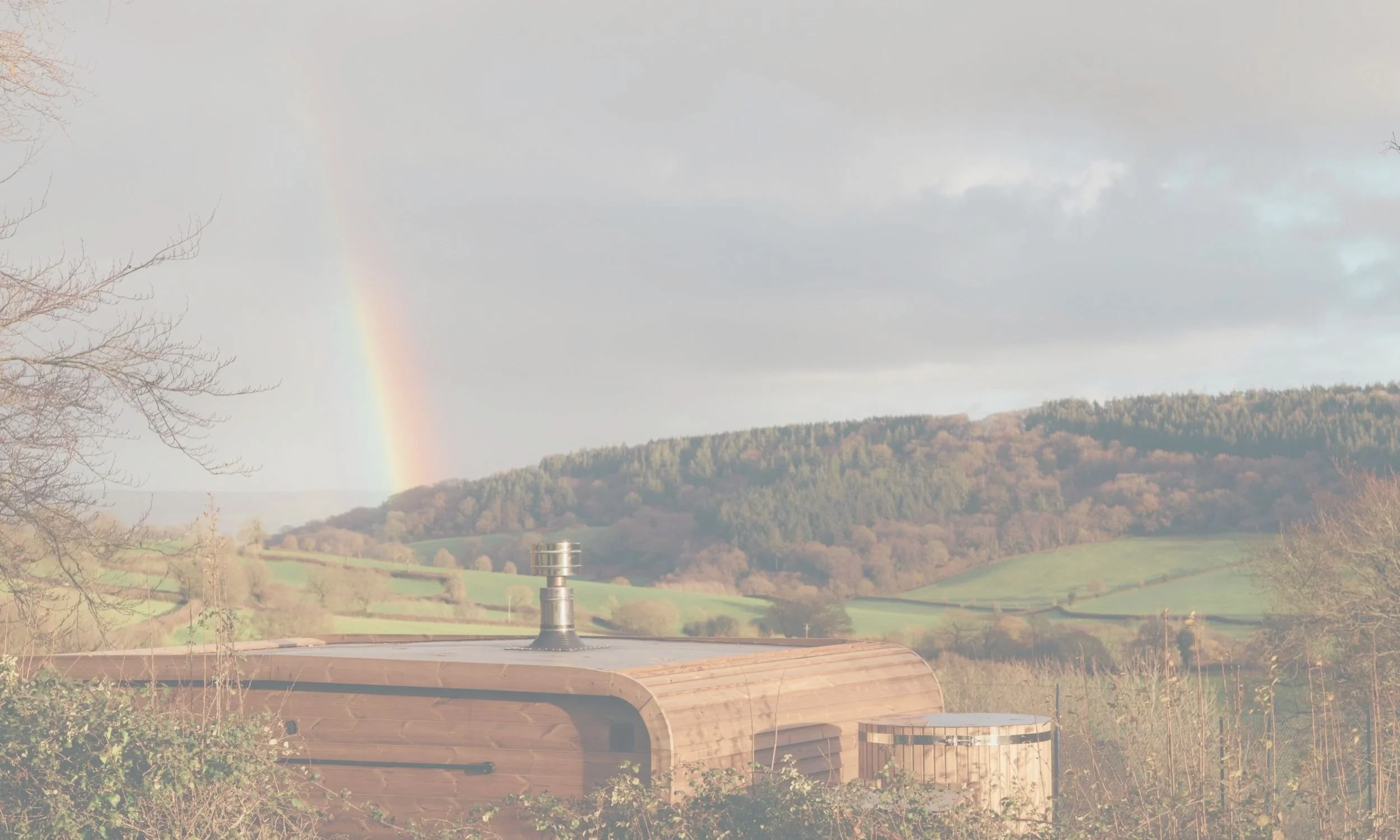 overlooking Jurassic coast from a sauna & cold plunge experience in Colyton, Devon