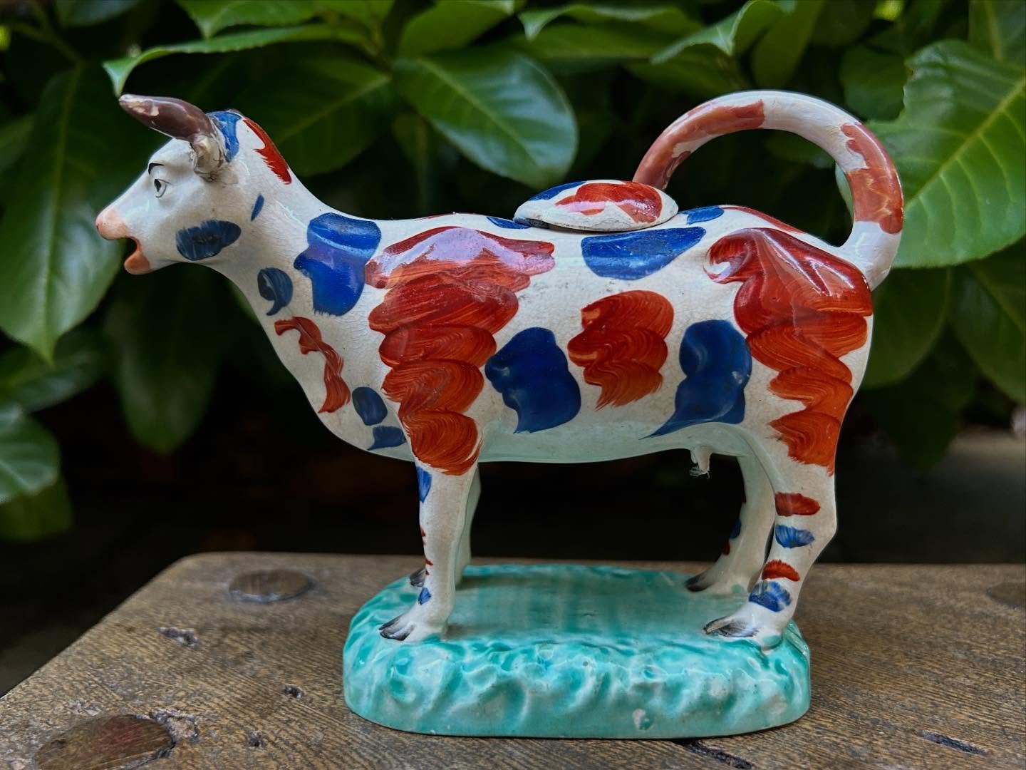 Lovely early 19th century Staffordshire pottery cow creamer, naively painted in red and blue. 
Unusual turquoise base. 
Restored horns and lid, tail has been remade. 
Height 13cm length 16cm 

#antiques #antiqueshop #staffordshirepottery