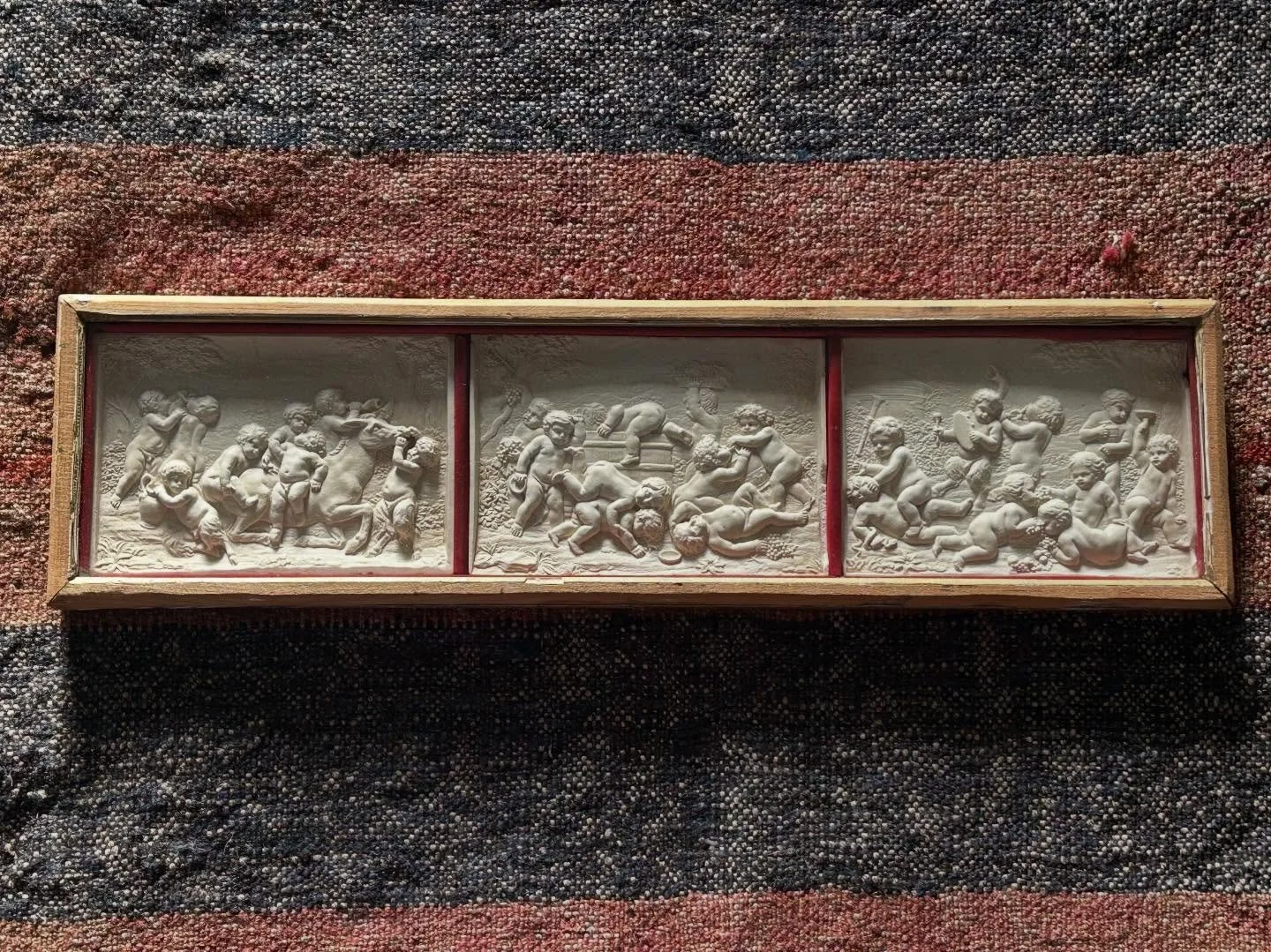 Framed set of three small 19th century neoclassical plaster plaques. The originals are 17th century marble by Francois Duquesnoy (copies seen in the V&amp;A) 
These are late 19th century and likely made by Elkington &amp; Co. 
Framed case size 51x14c