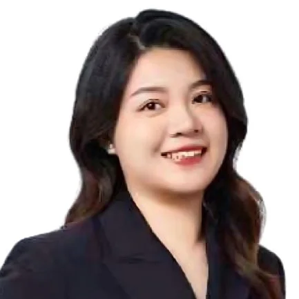 Professional woman with black hair and a smile, wearing a dark blazer against a white background.