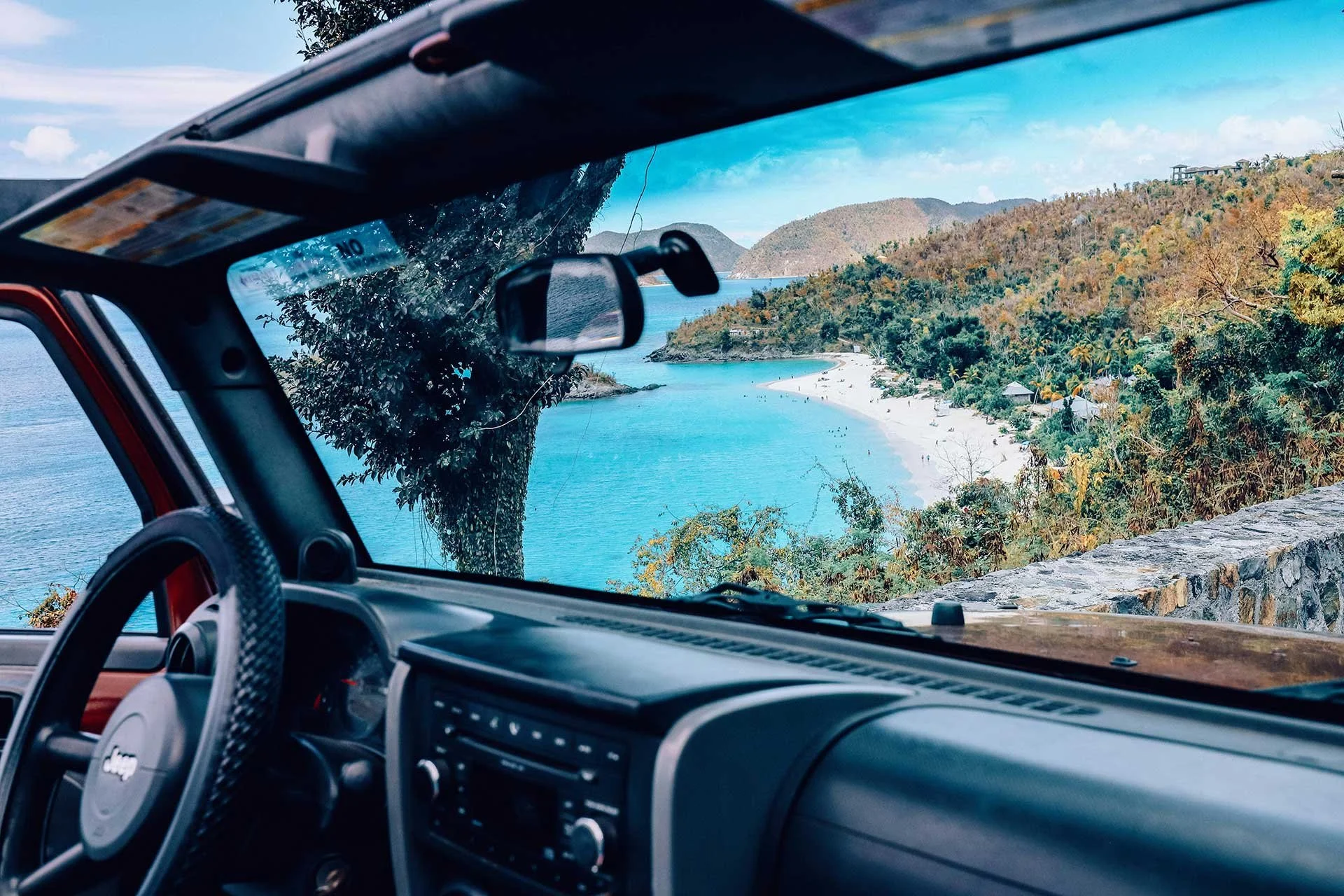 Interior of a Jeep, with views of St John out the windshield