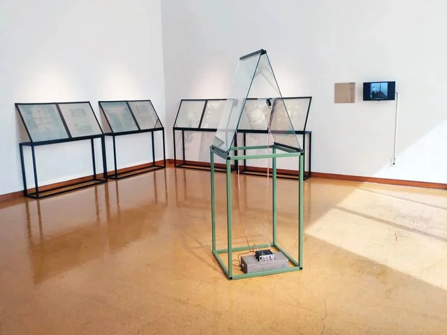 Resonance, installation by Carrie Iverson featuring glass, steel display structures, video, and sound exploring material memory and perception.