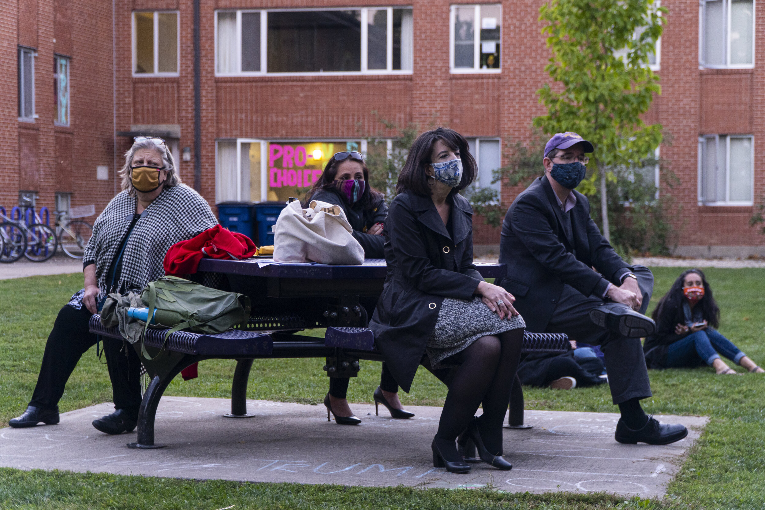  Staff and Faculty sit at the picnic table watching and listening to students protest. (Rob Nguyen/TKS) 