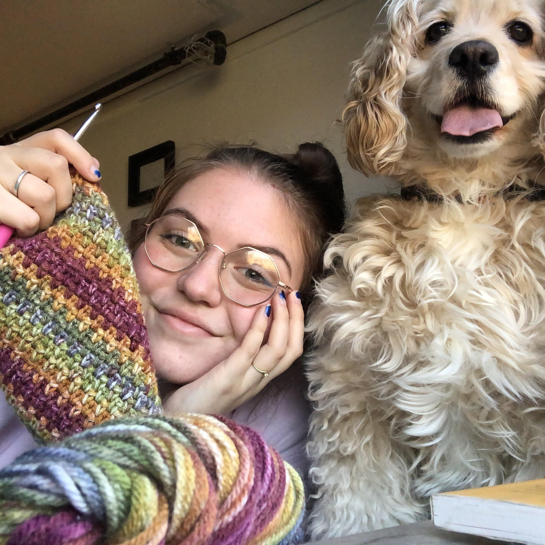 Co-President Maddie Tucker with some crocheted fabric and her dog. (Courtesy of Maddie Tucker)