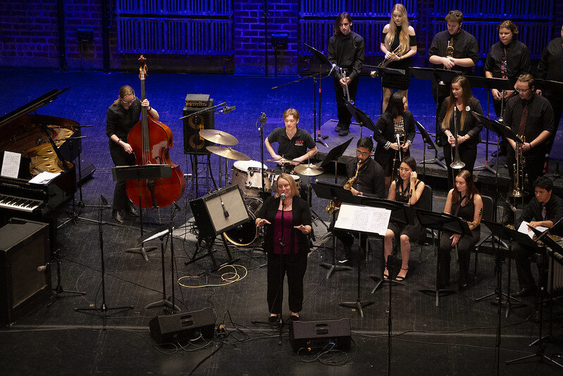 Nikki Malley addressing an audience at the Orpheum Theater for the Jerome Mirza Residency concert of 2019. Daniel Bien is in the bottom left corner. (Courtesy of Knox Flickr)