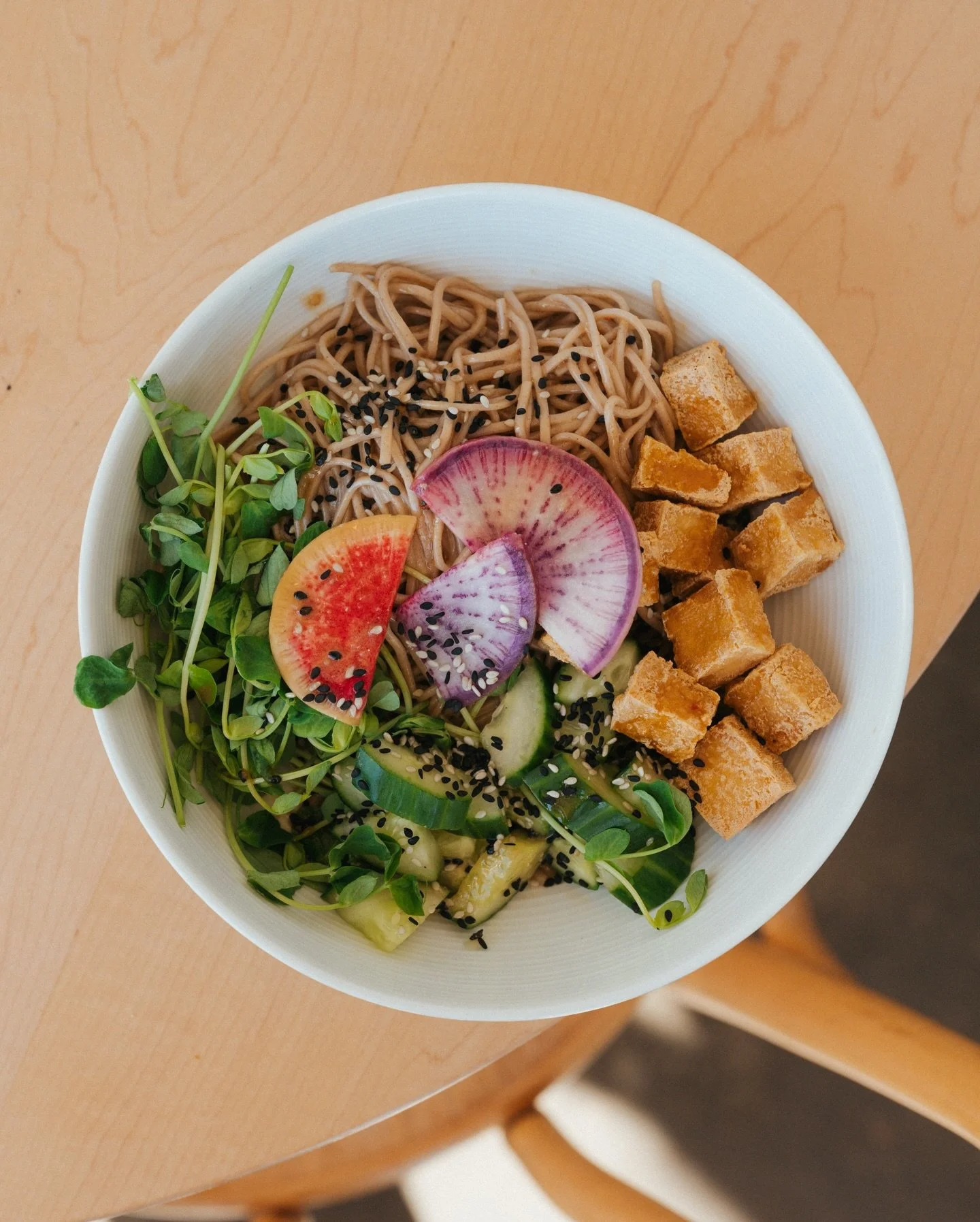 we're feeling a spring in our step these days 🤭 new menus for the warmer season are here! stop by and try our soba noodles + other spring goodies! 🍜⭐️

a dish full of soba noodles, crispy tofu, refreshing cucumber, fresh + crunchy radishes, and som