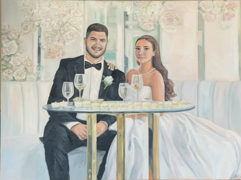 A painting of a newlywed couple sitting at a table during their wedding celebration, with a backdrop of roses and greenery. The husband wanted to surprise his wife with a custom made painting of their wedding day, to gift for their 1 year anniversary