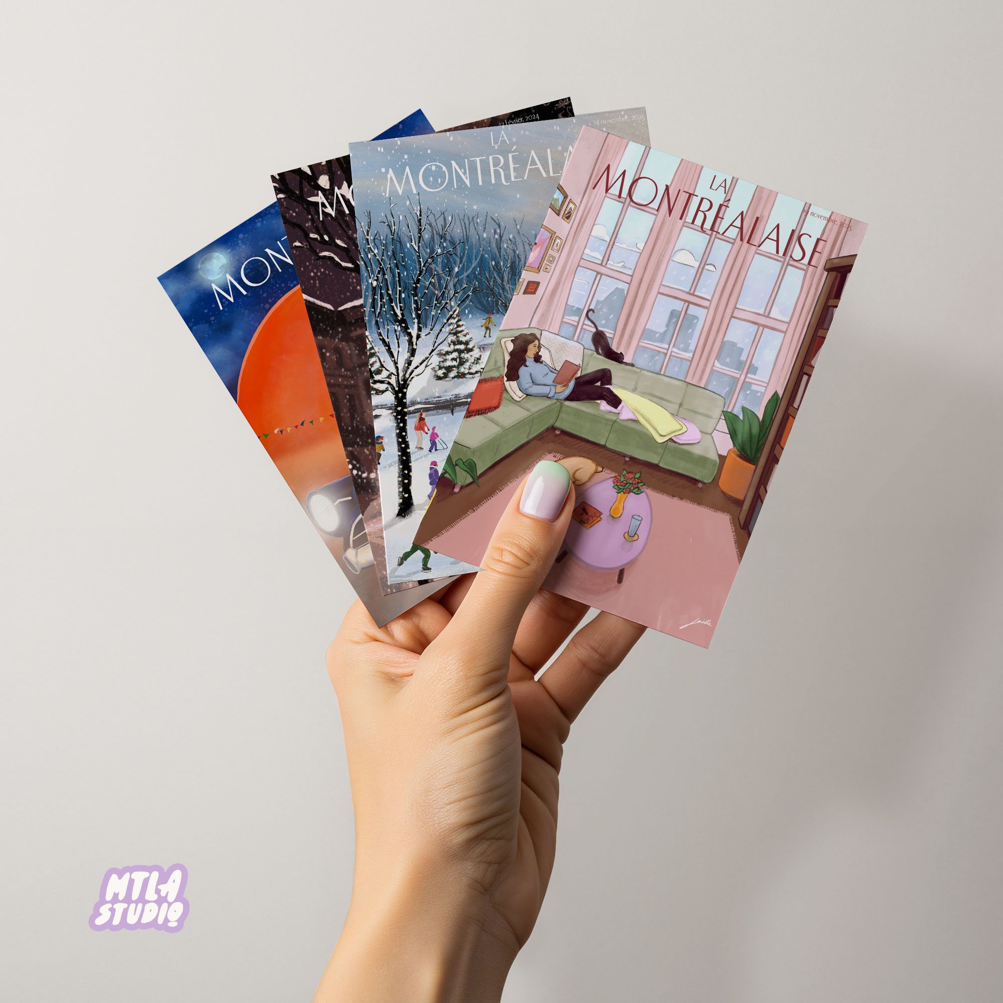 A hand holding four illustrated postcards with Montreal-themed scenes, including winter landscapes and a cozy indoor setting, against a plain light gray background.