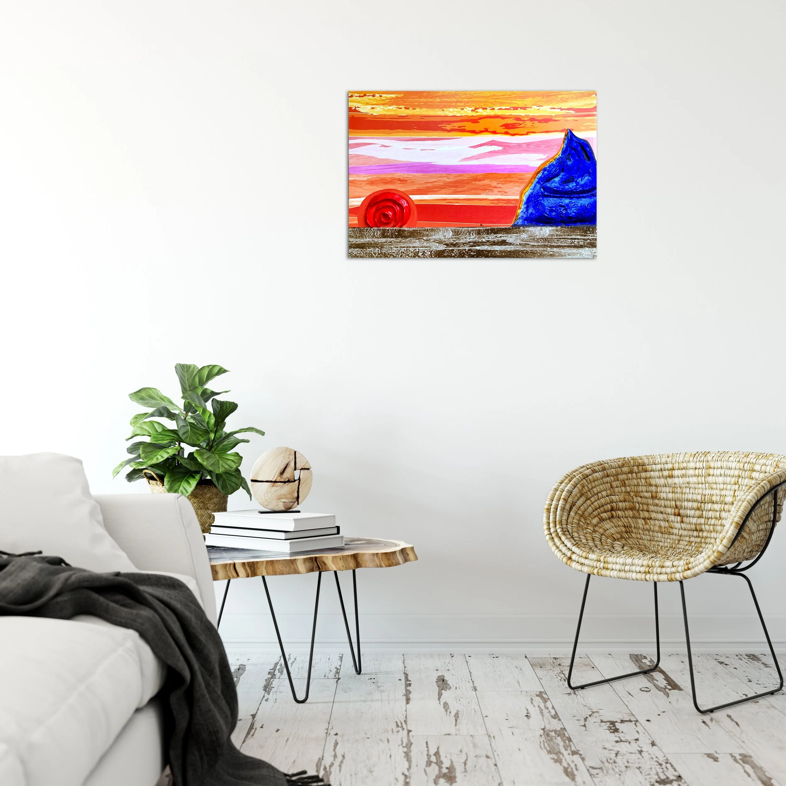 Minimalist living room with a white sofa, a wooden coffee table with black metal legs, a potted green plant, a stack of books, a decorative sphere, a wicker chair, and a colorful abstract painting on the white wall.