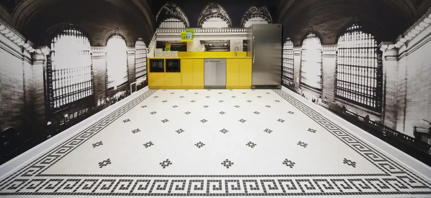 Nuts dot com office kitchen millwork with yellow cabinets and black and white floor and black and white mural