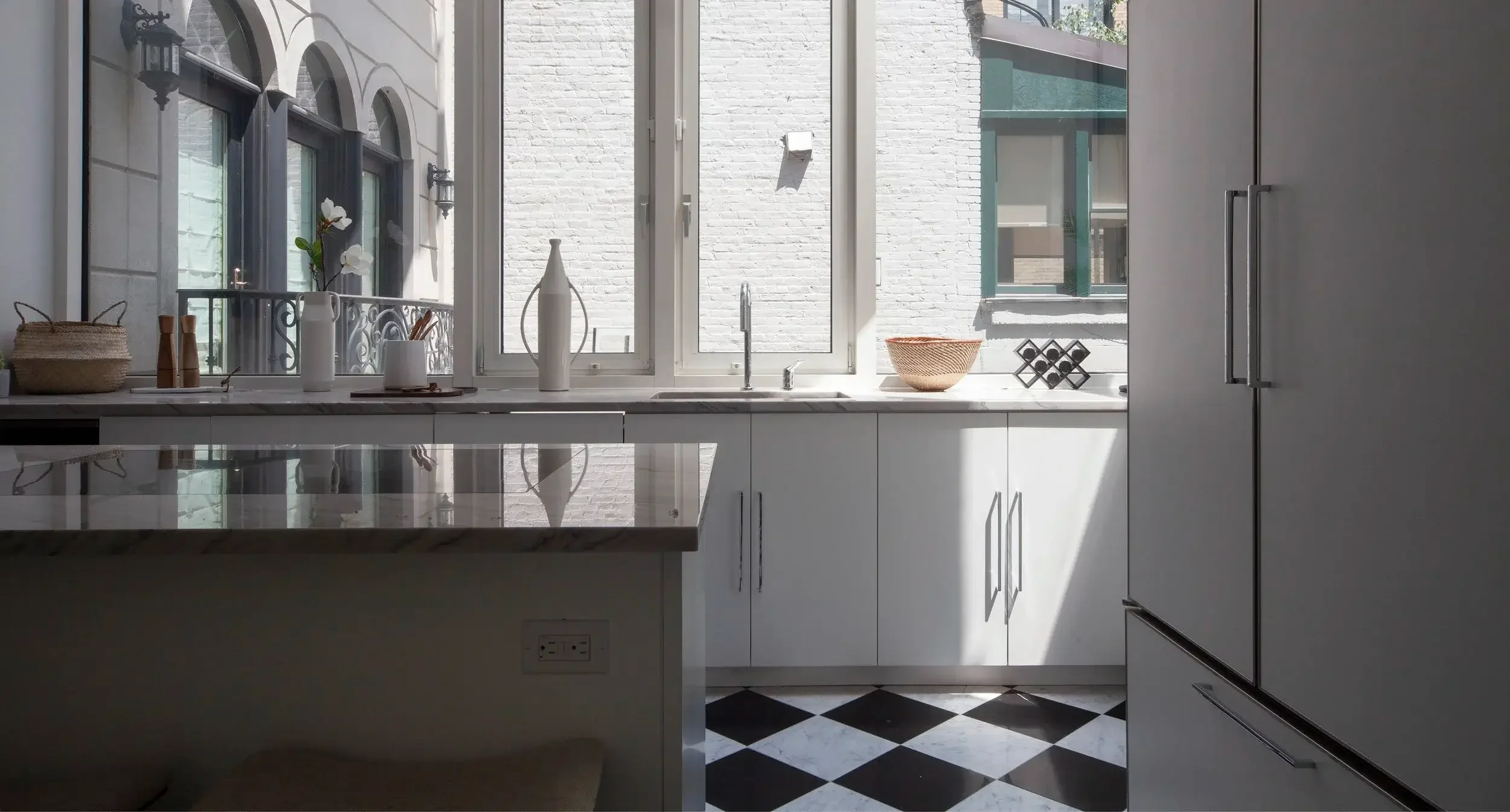 Black and white modern kitchen with big window and checkered floor