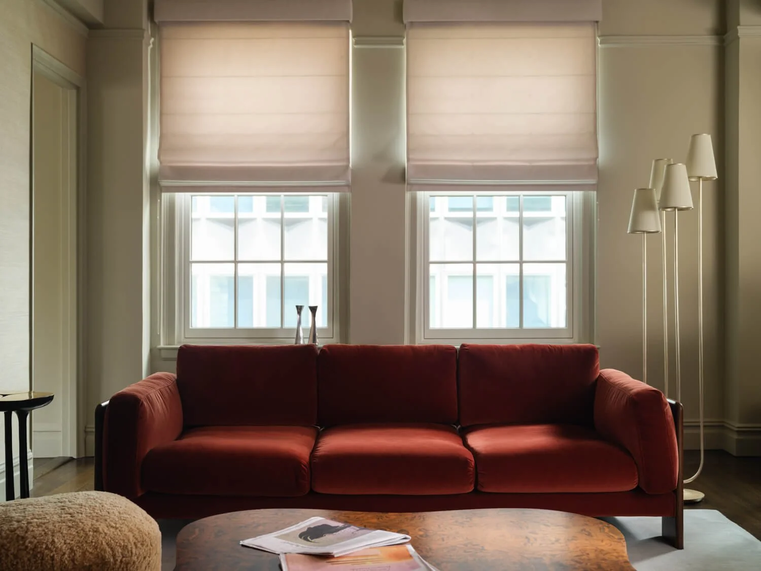 Pre-war living room renovation with red velvet sofa, powder blue rug and Brooklyn Bridge salvage collection