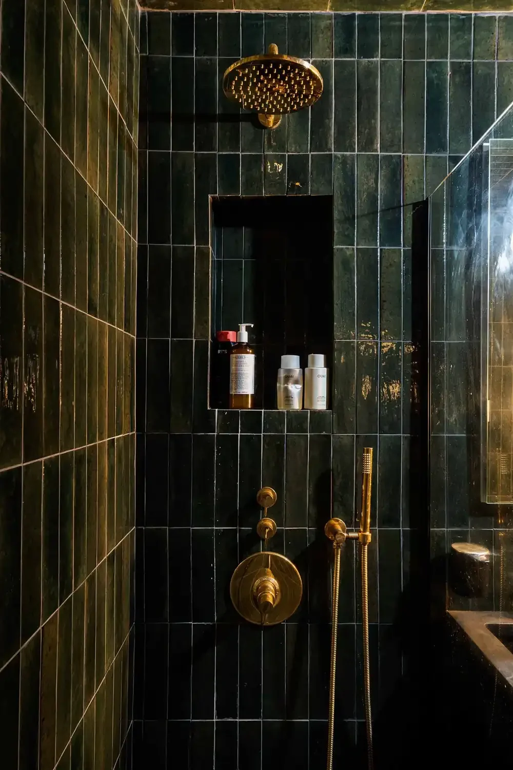 Dark tiled shower view from a detailed revamp of a studio apartment in Manhattan's Gramercy district