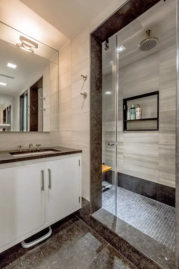 Chelsea apartment interior renovation with marble standup shower and teak seat