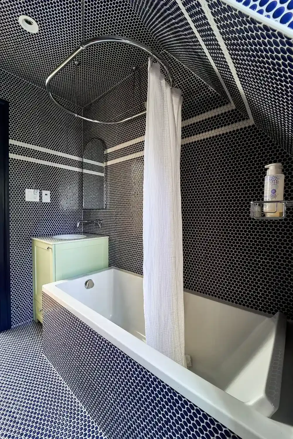 Bathtub in renovated blue tile bathroom