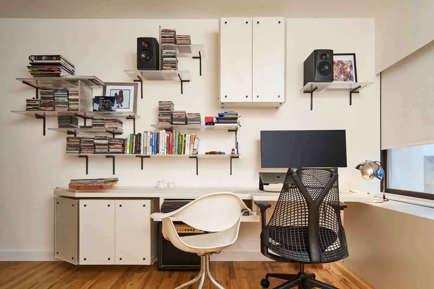 Simple home office with shelves and two desk chairs