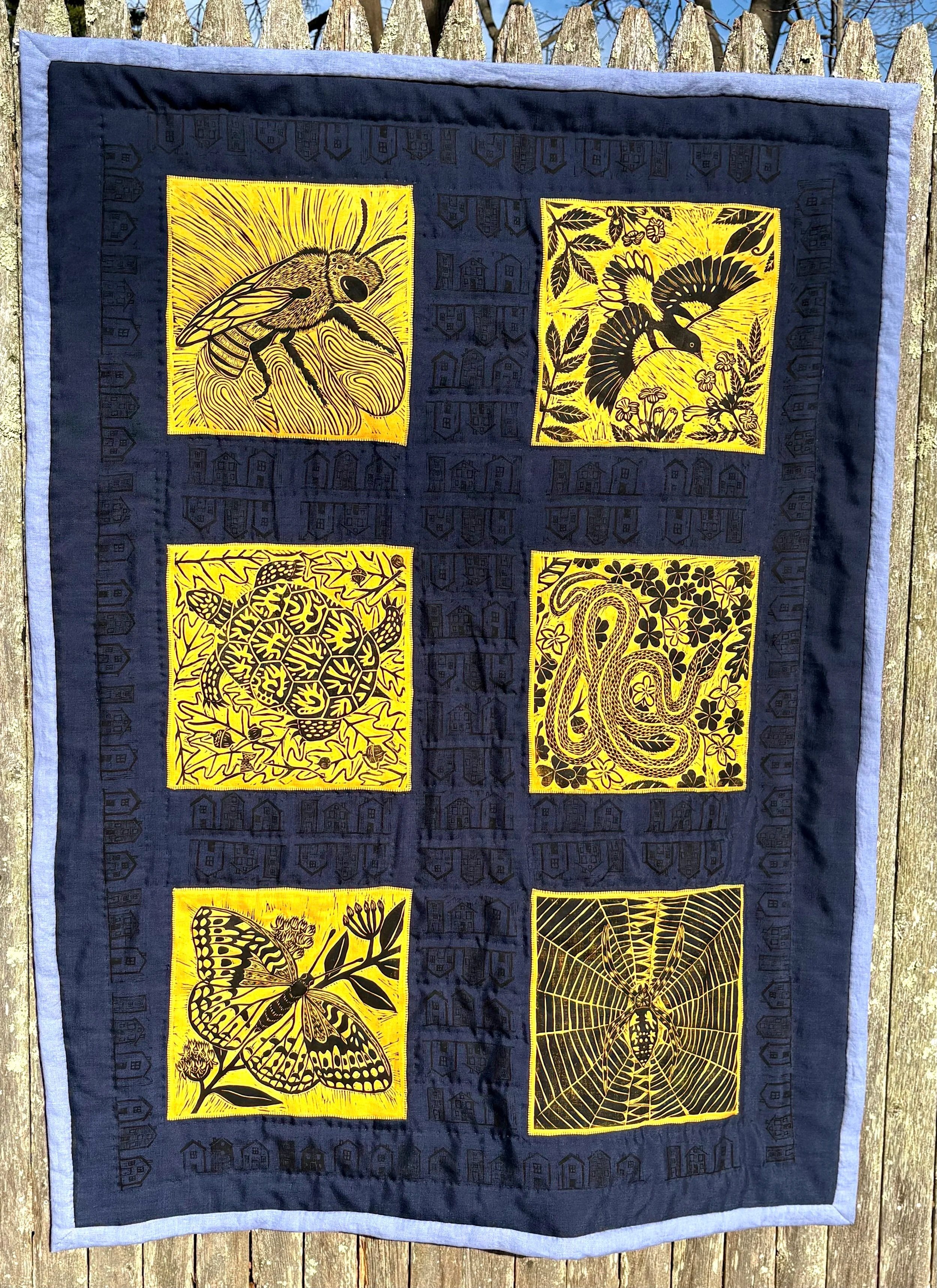 "The Golden Ones," linen lap quilt with linocut prints of squash bee, Baltimore oriole, Eastern box turtle, garter snake, great spangled fritillary butterfly, and writing spider