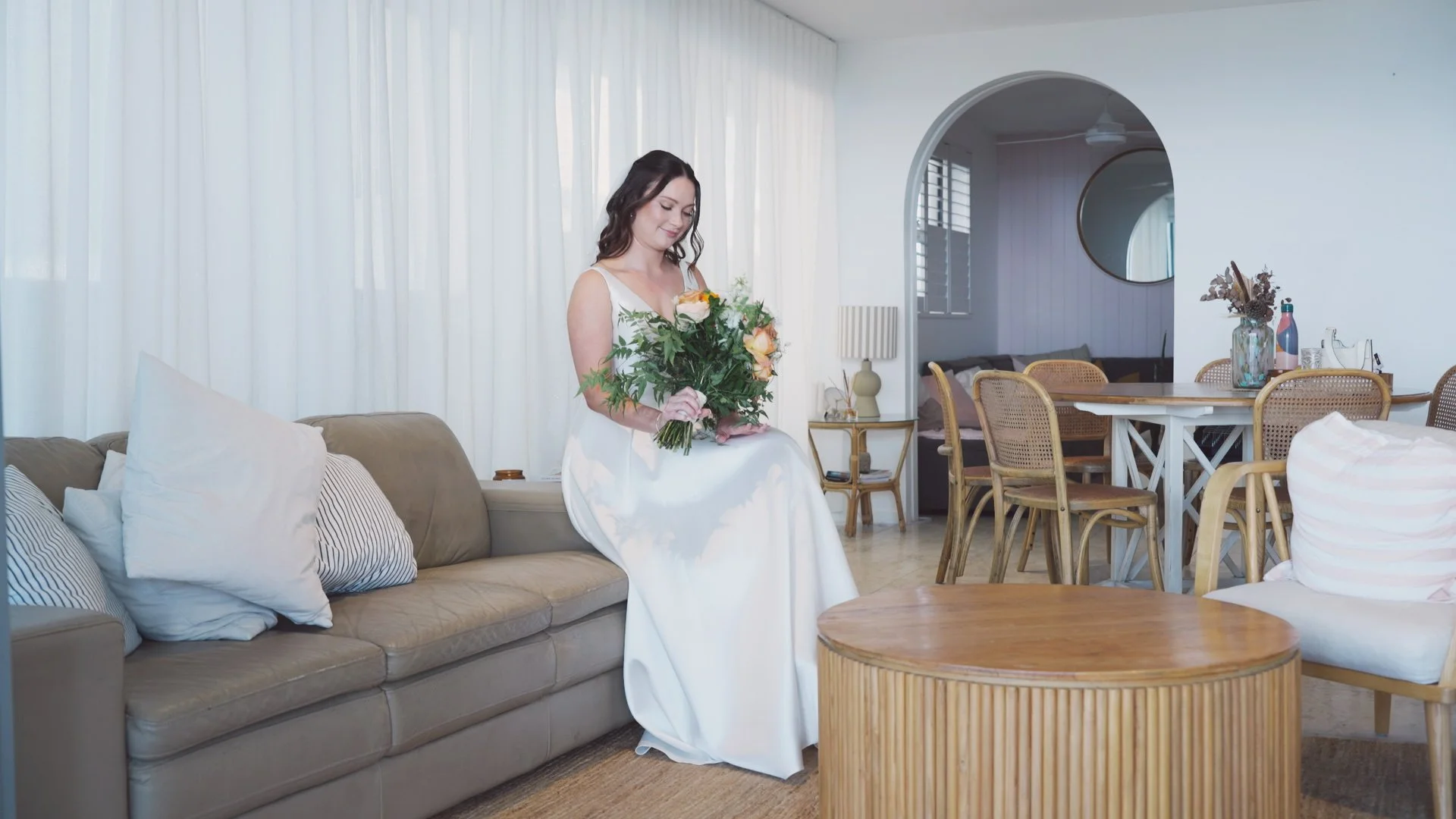 bride smiling at wedding bouquet.jpg
