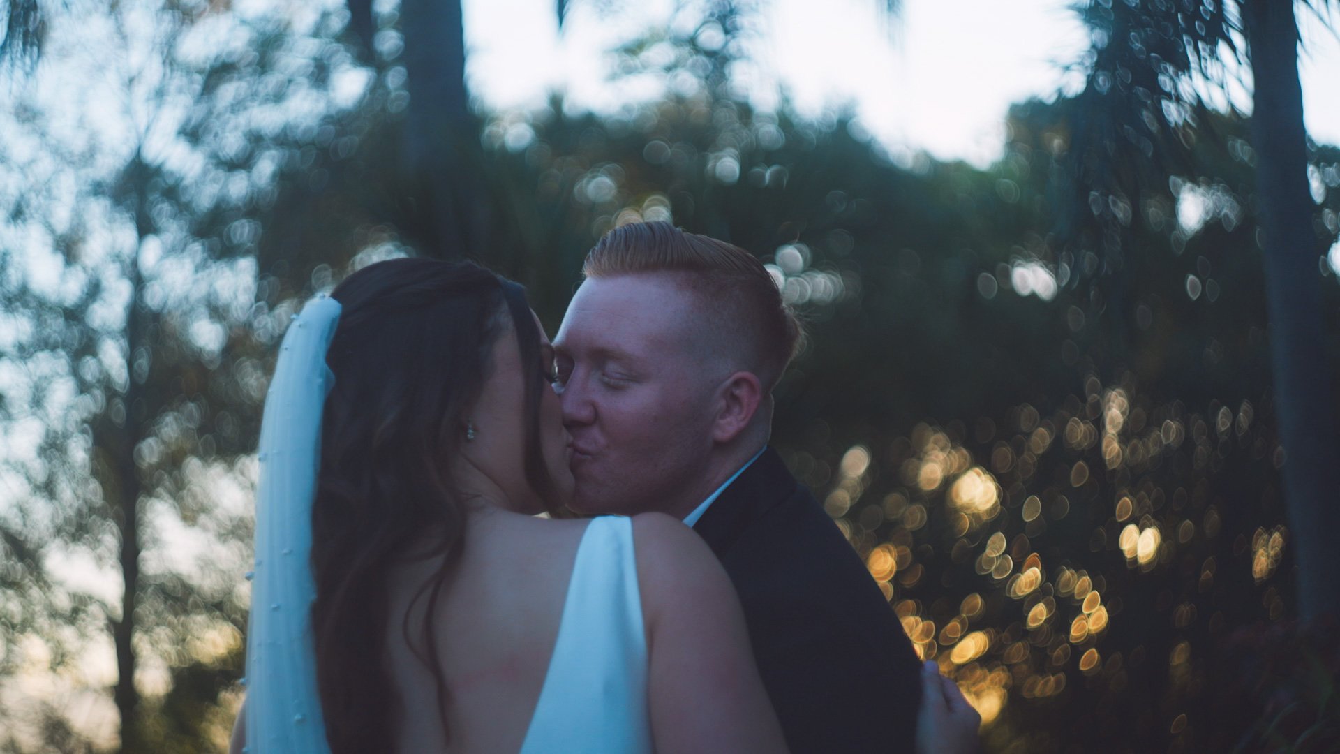 bride and groom kissing figs at the plantation wedding arrangment.jpg.jpg