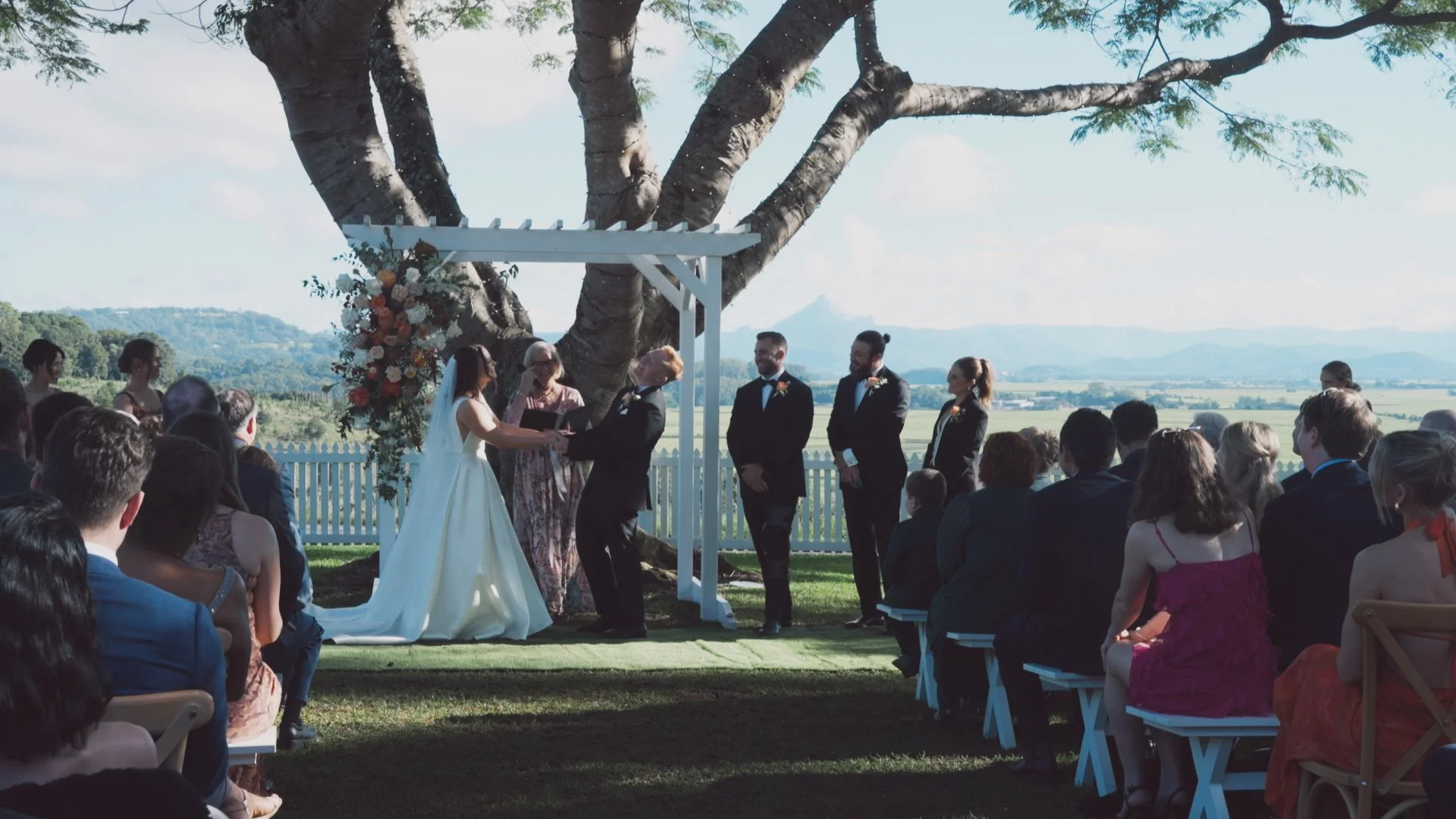 wedding party bride and groom laughing at the alter.jpg
