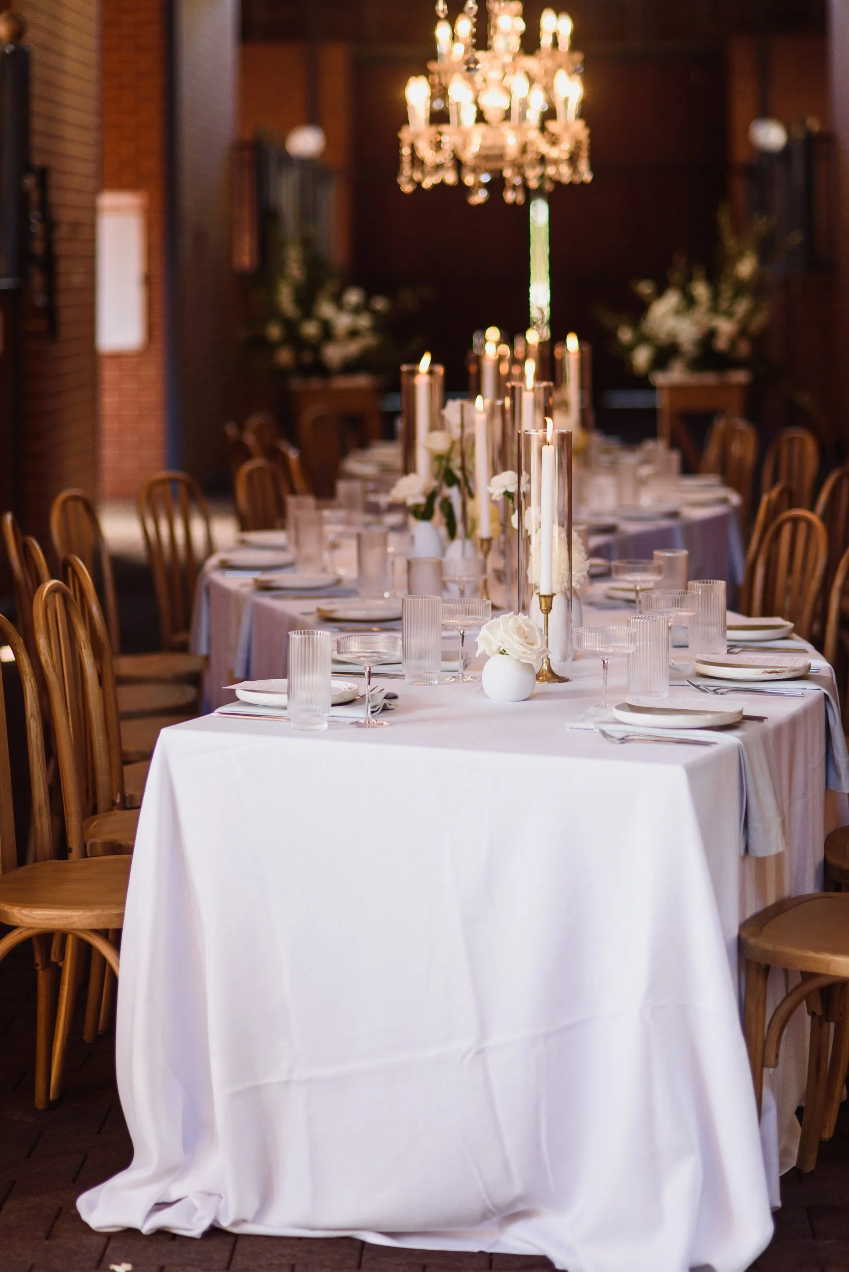 Curved wedding tables set in a Barn at Brookleigh Estate