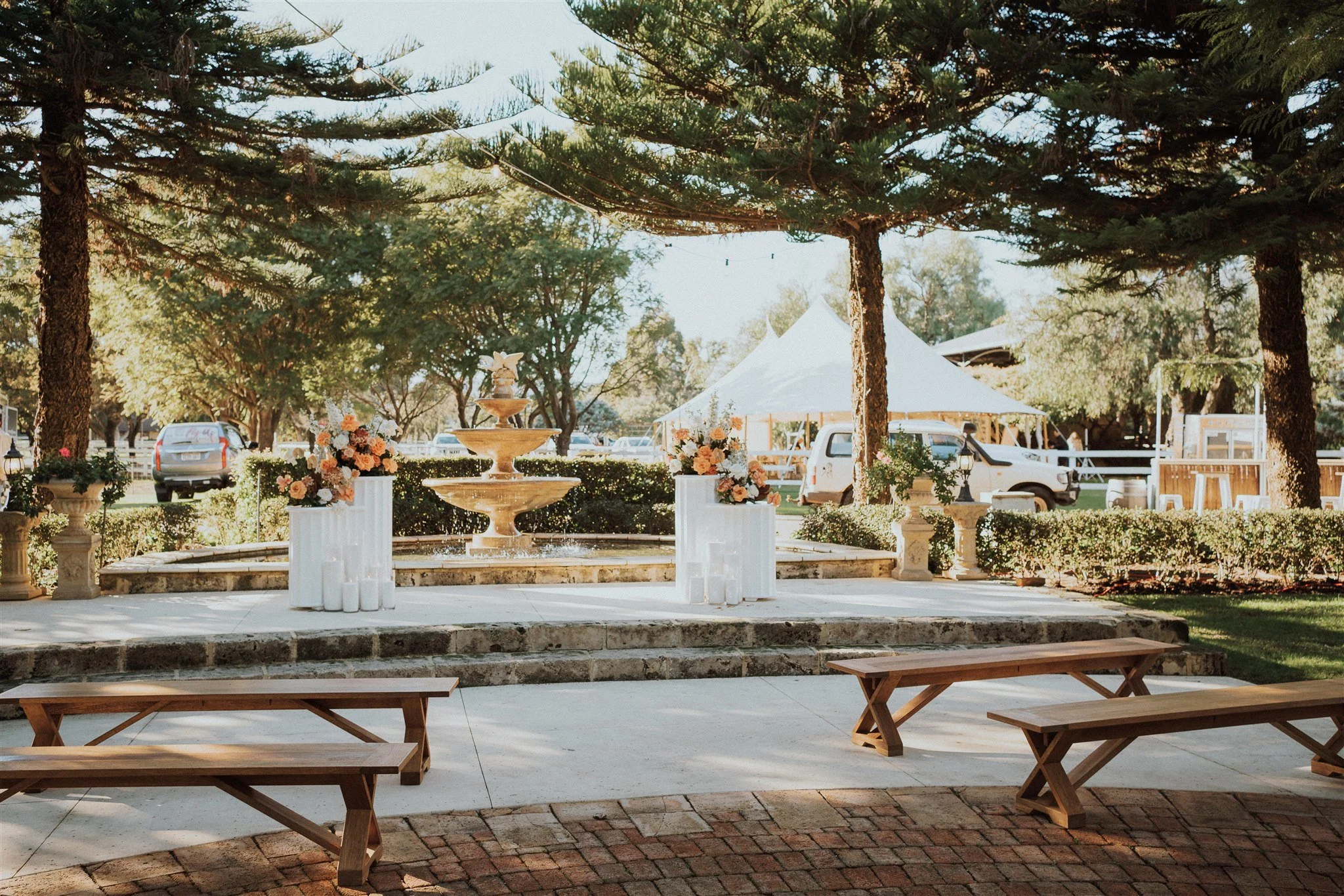 Double Curved Plinths styled with flowers at a wedding ceremony