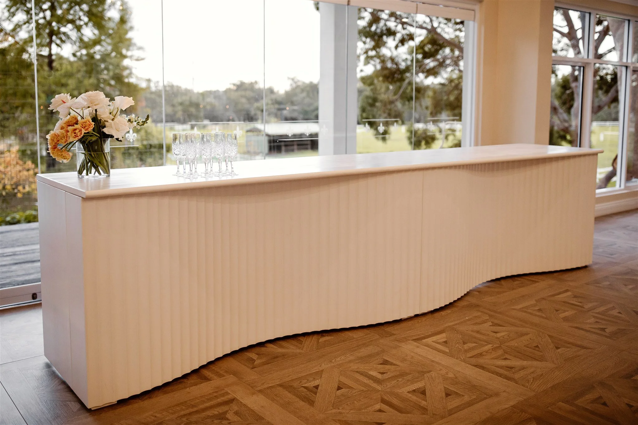 Curve detail on the double Monaco white curved bar at a wedding reception