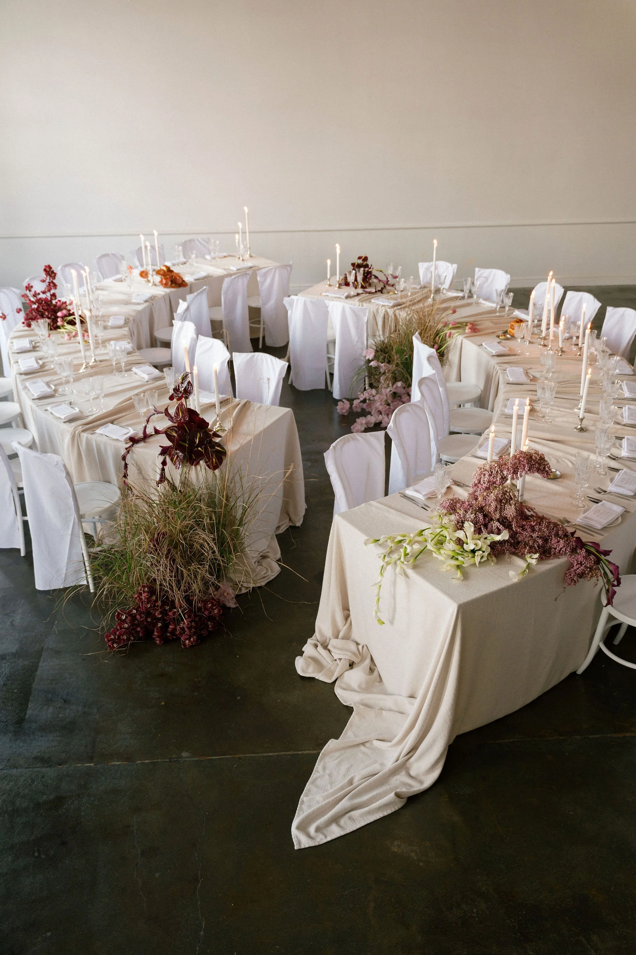 Two Steph Tables setup in a double curve wedding floor plan at Cleaver House