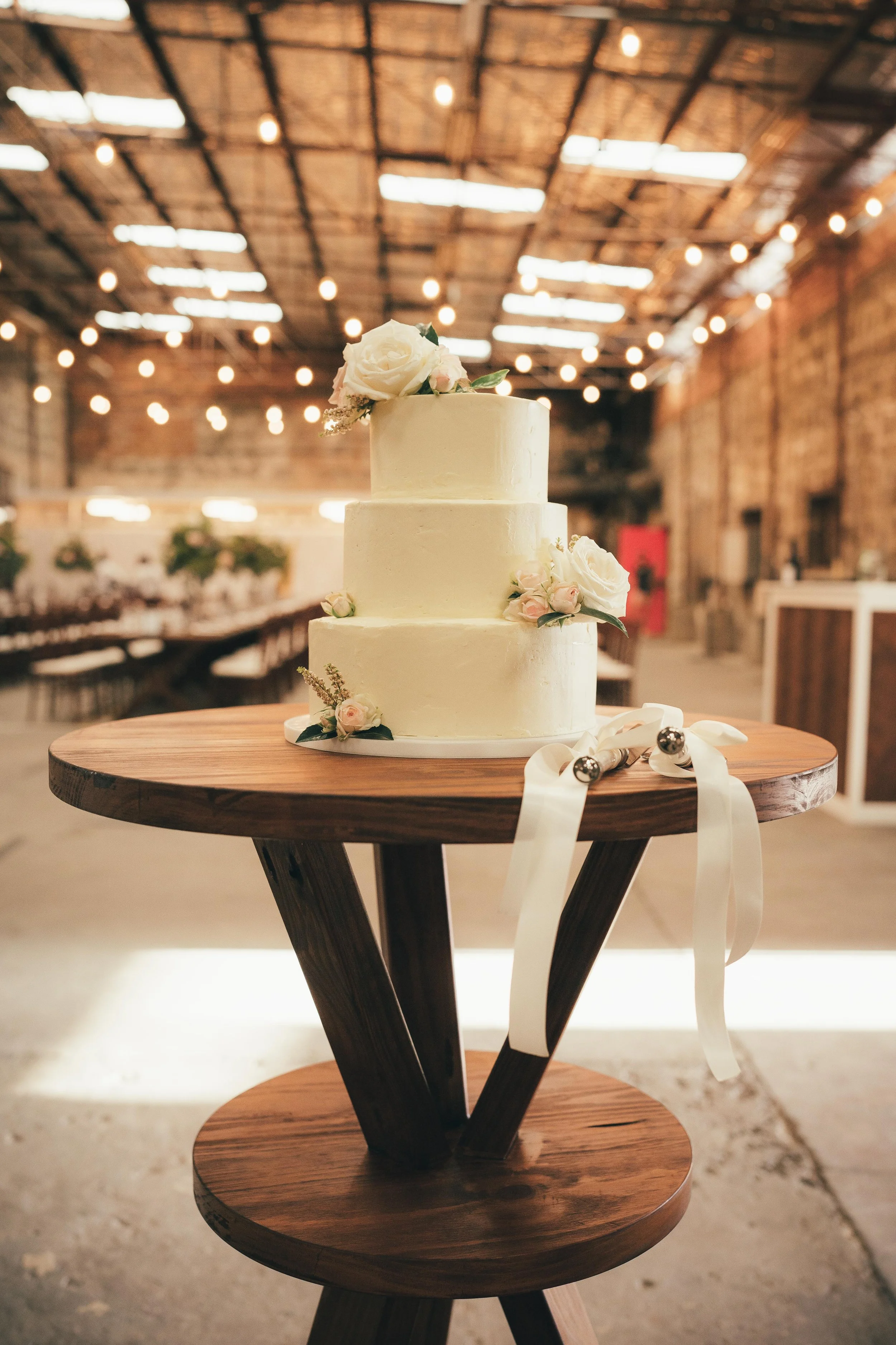 Walnut cocktail table used for a cake table at a wedding reception