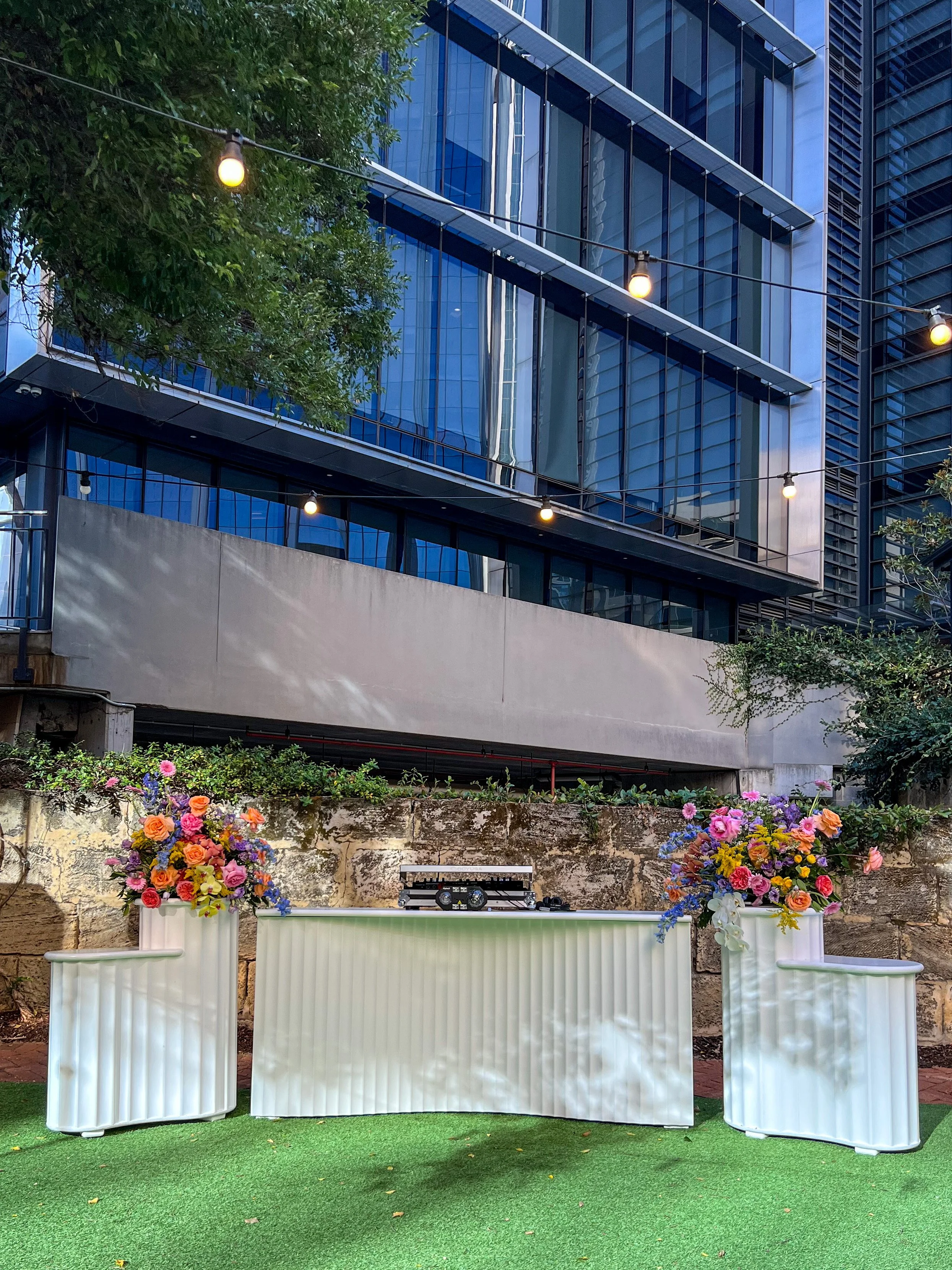 Monaco white wedding bar with floral styling on double curved plinths