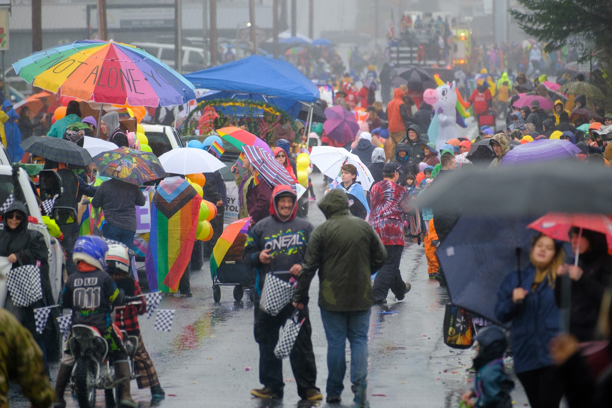 7. Hundreds of people gathered along the streets despite the rain to see the floats and receive candy, beads, and flags from floats, May 27, 2023.  (Brian Venua, KMXT).jpg