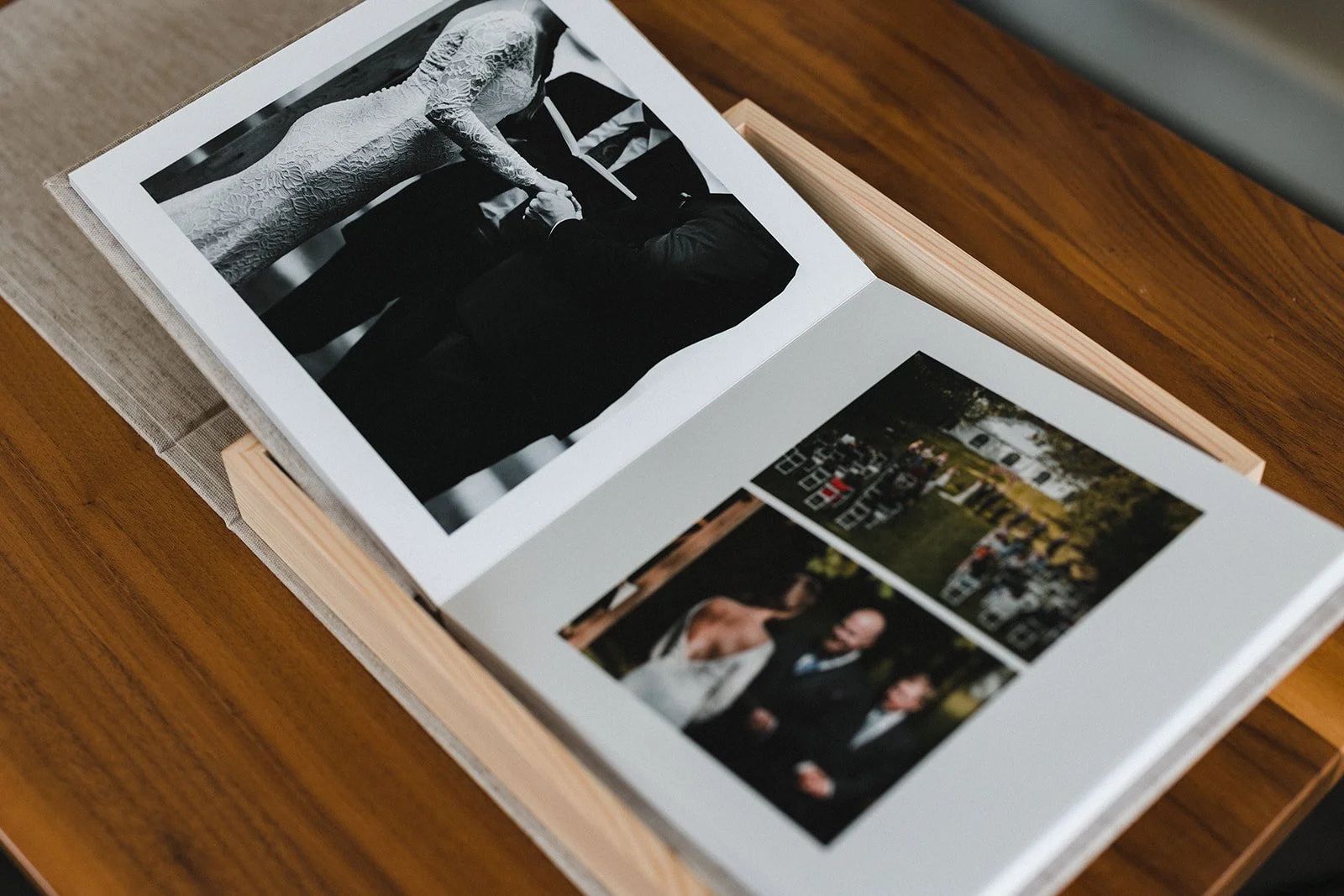 Open photo album with black and white wedding photo and colorful outdoor wedding photos.