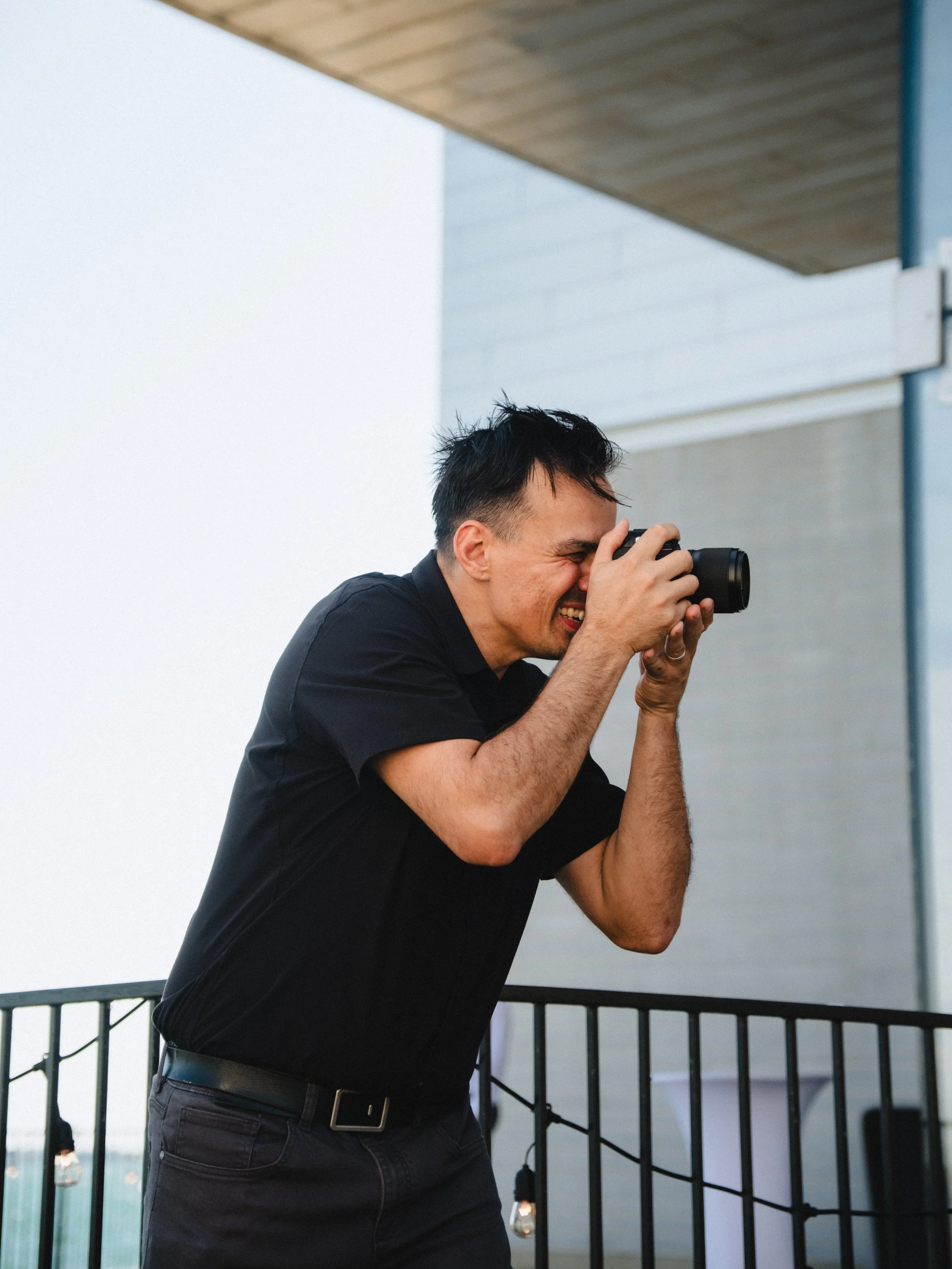 Josh Sauer taking a photo of a family at a wedding at the Isabel Bader Centre in Kingston, Ontario.