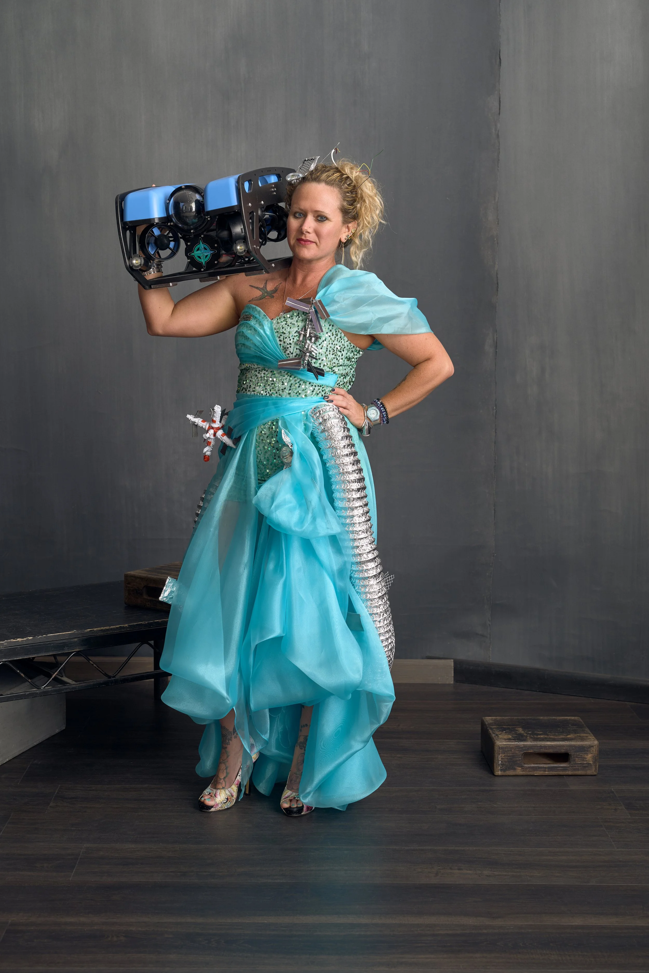 Breezy Grenier, holding the Blue Robotics "BlueROV2" - a remotely operated underwater vehicle she use for boat hull and prop inspections, underwater surveying, search operations, and real-time marine life observation and exploration.