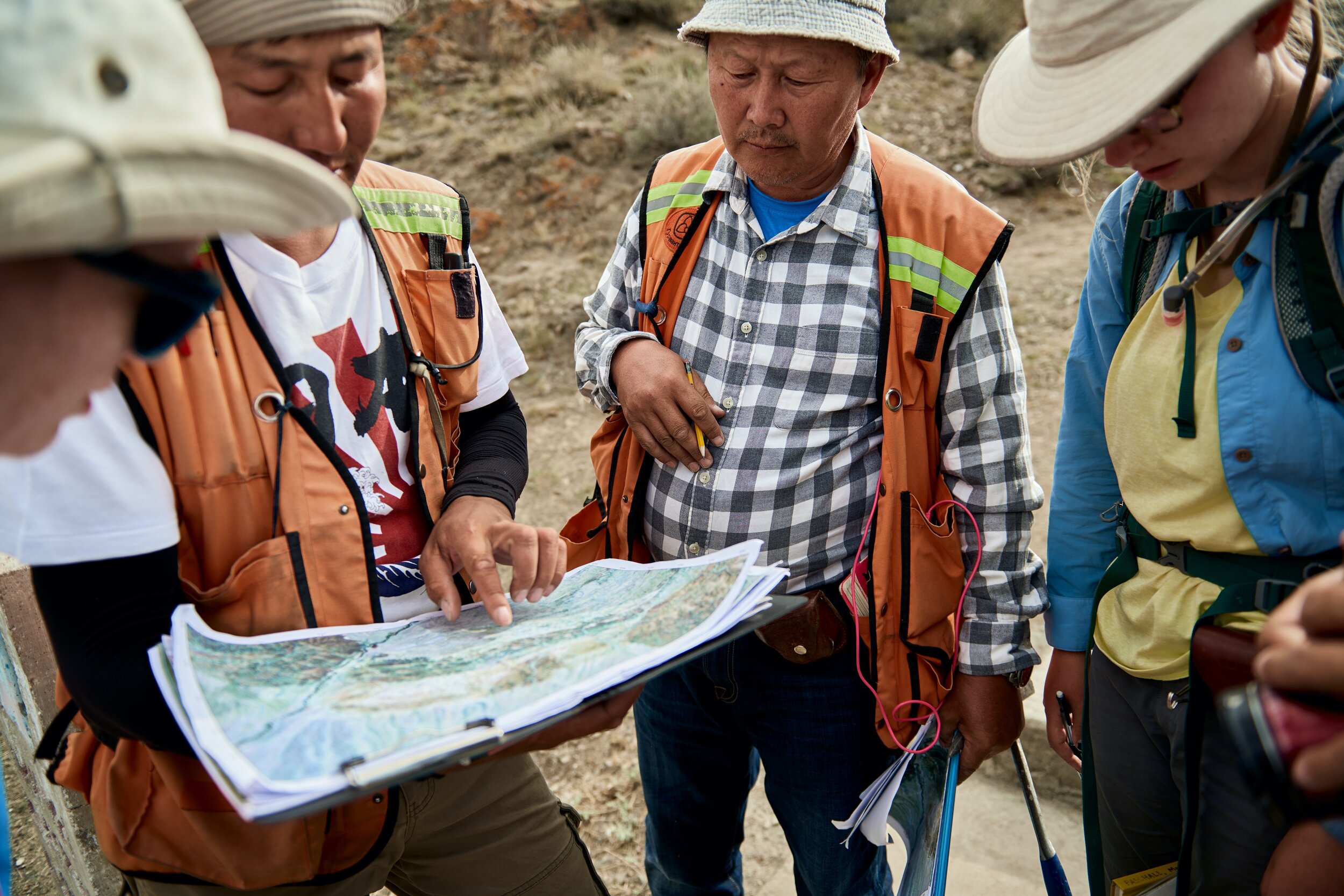 The team reviews their maps