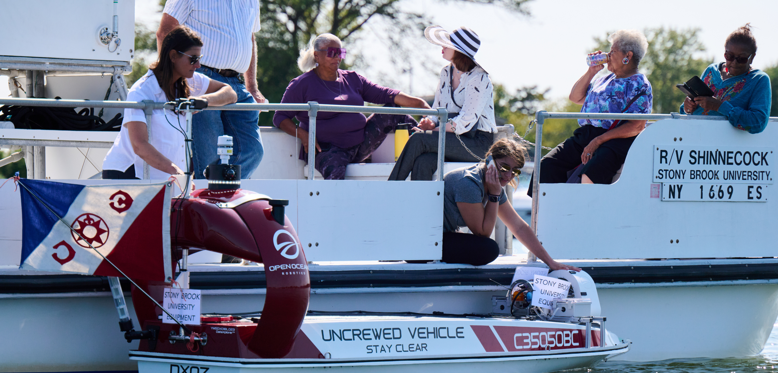 DataXplorer, a 12-foot Unscrewed Surface Vessel outfitted with an environmental DNA (eDNA) sampler. The flag denotes the Explorers Club expedition for this project. 