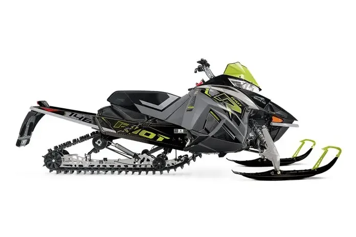 Black and gray snowmobile with yellow accents and a green windshield.