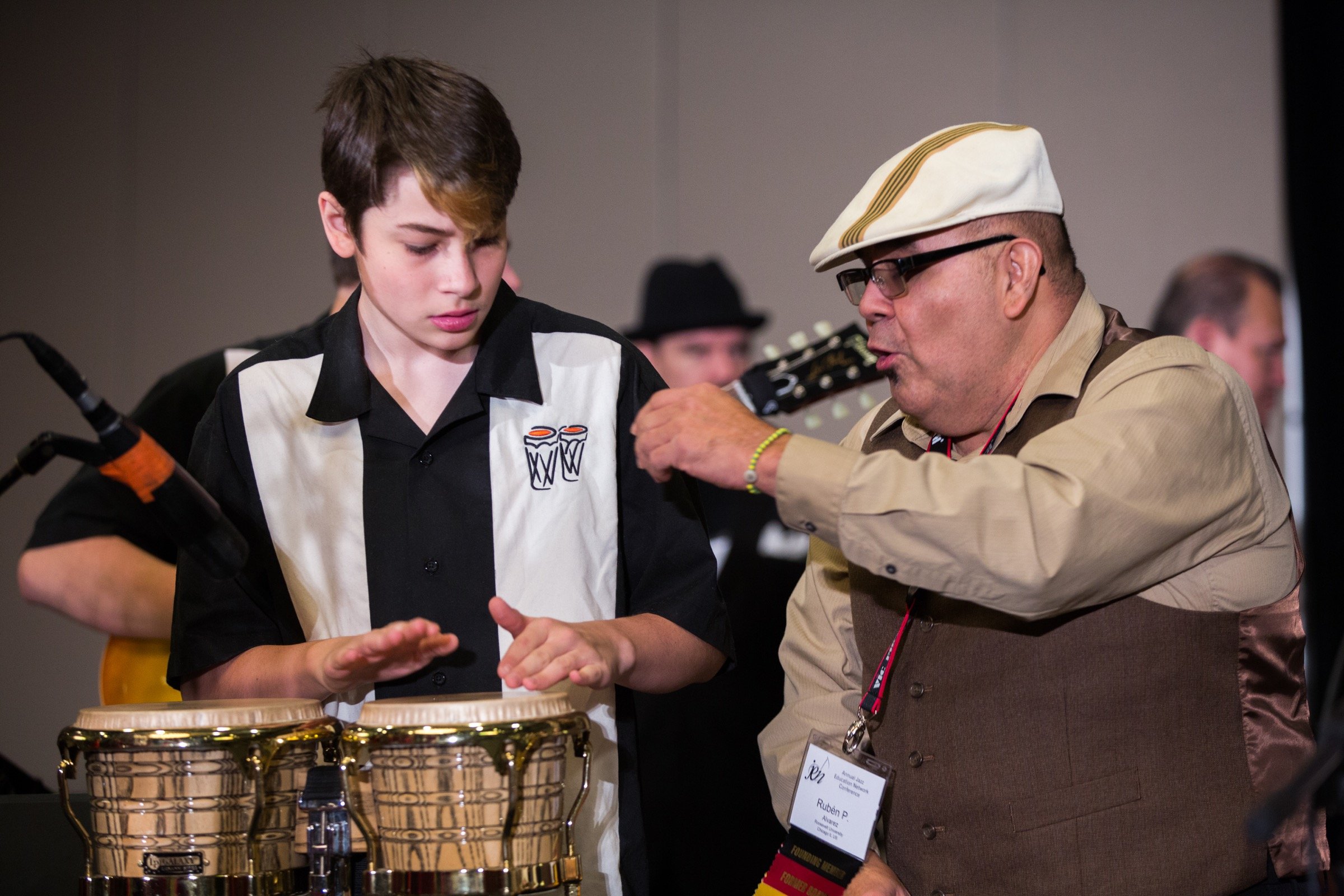 A visiting percussion artist coaching a young Soundhouse musician