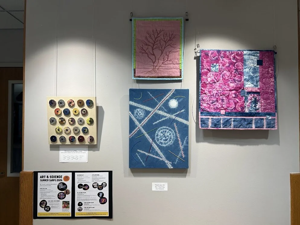 Library Exhibit 2026 Collaborative Clay Disk project Hilary quilts.jpg