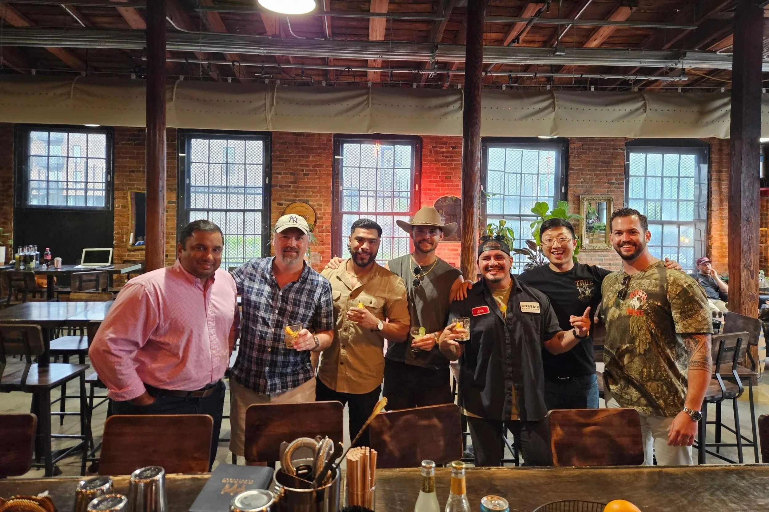 A Nashville bachelor party touring a local distillery, sampling whiskey.