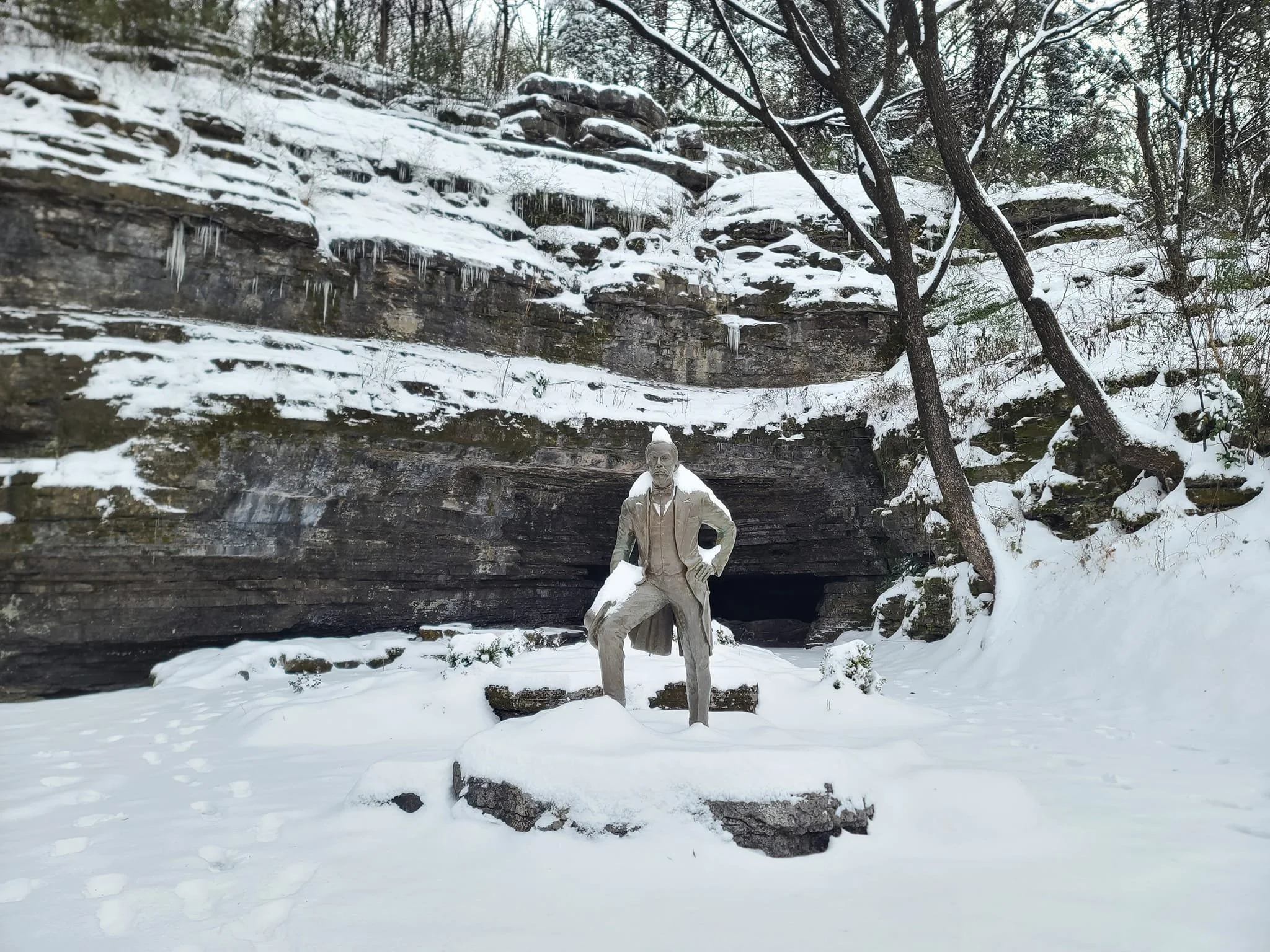 Statue of Jack Daniel covered in snow in the winter time.