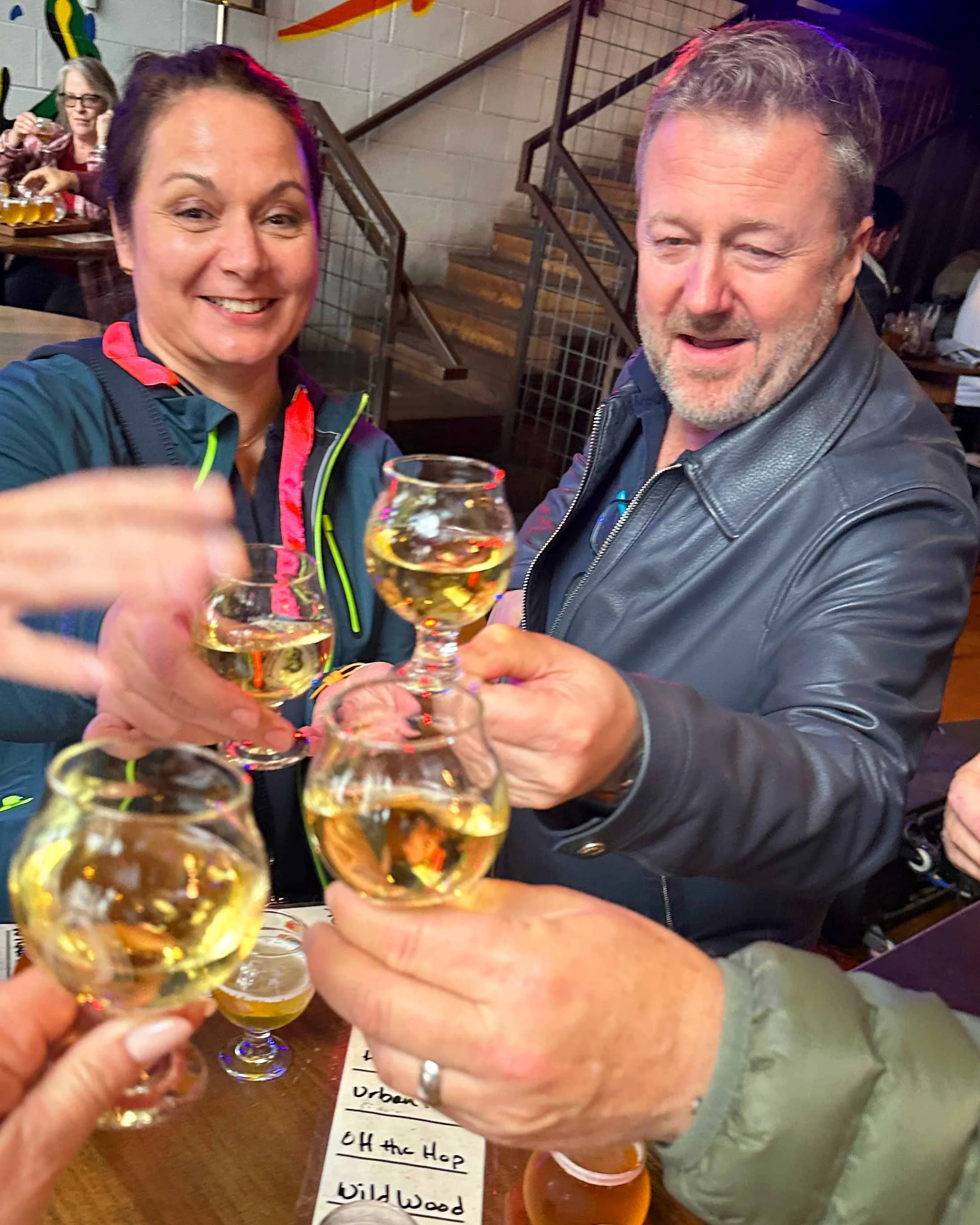 Group engaged in a cheers with drinks, while participating in a Tennessee whiskey Tour.